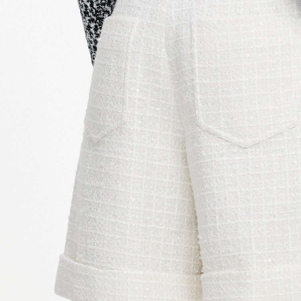 A close up of the fabric for the Cream Sequin Boucle Tailored Shorts