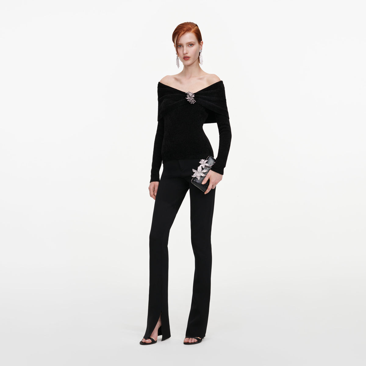 Side view of a woman wearing the Black Brooch Chenille Knit Top