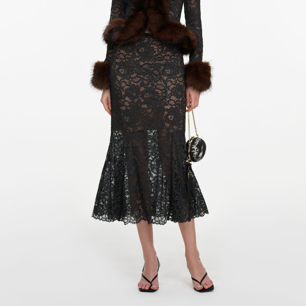A close up of a woman wearing the Grey Lace Midi Skirt