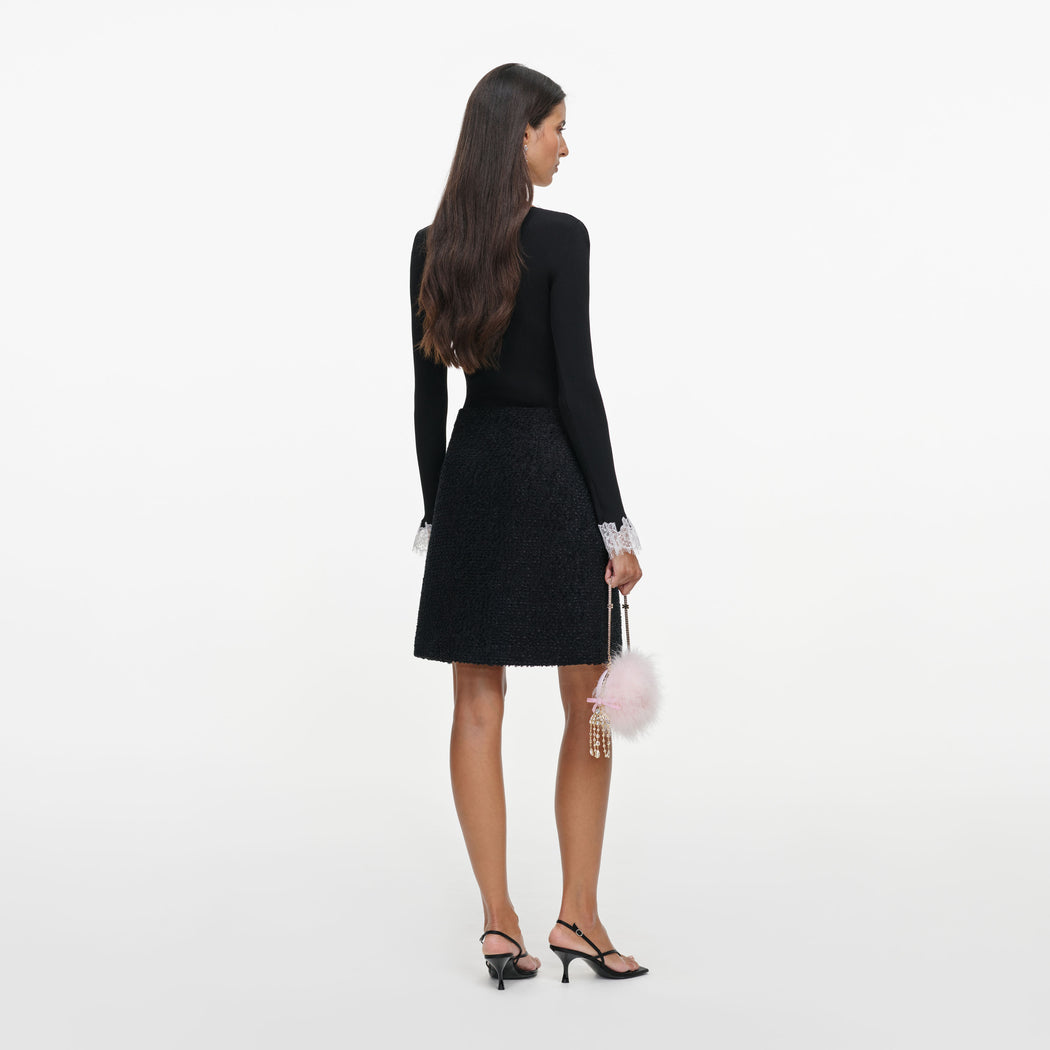 Back view of a woman wearing the Black Lace Trim Rib Knit Bodysuit