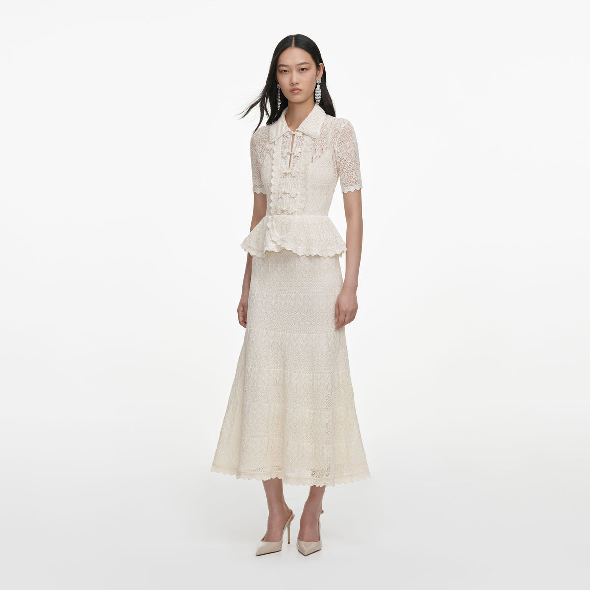 Side view of a woman wearing the Cream Pointelle Knit Wrap Peplum Midi Dress
