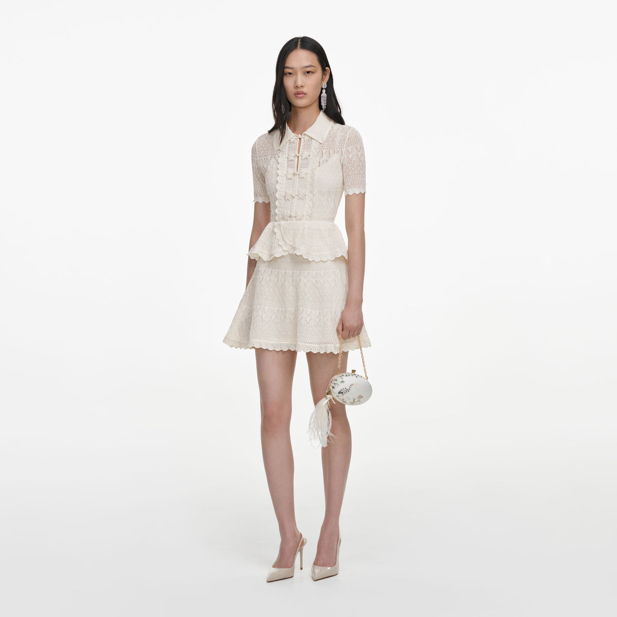 Side view of a woman wearing the Cream Pointelle Knit Wrap Peplum Dress