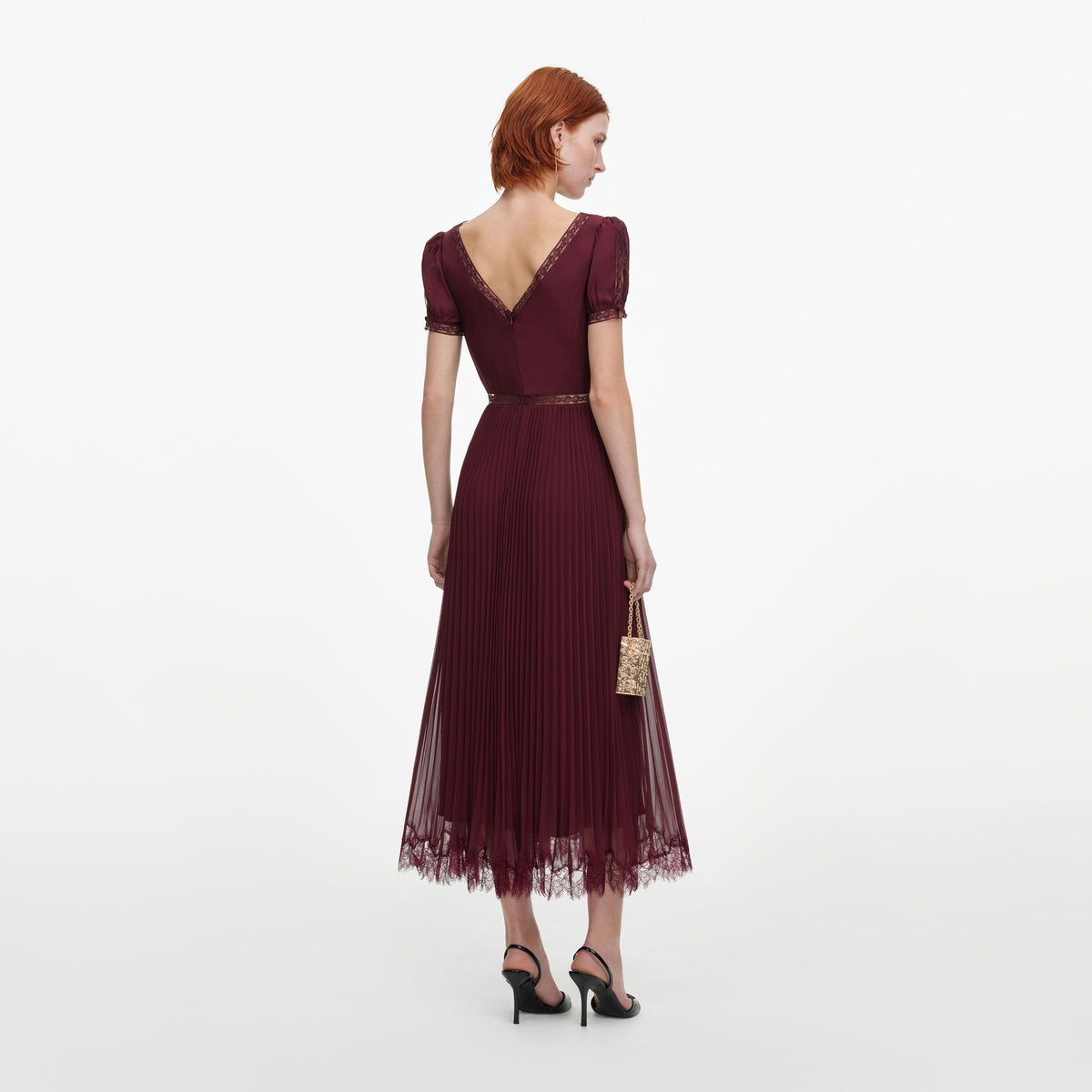 Back view of a woman wearing the Burgundy Viscose Pleated Lace Midi Dress