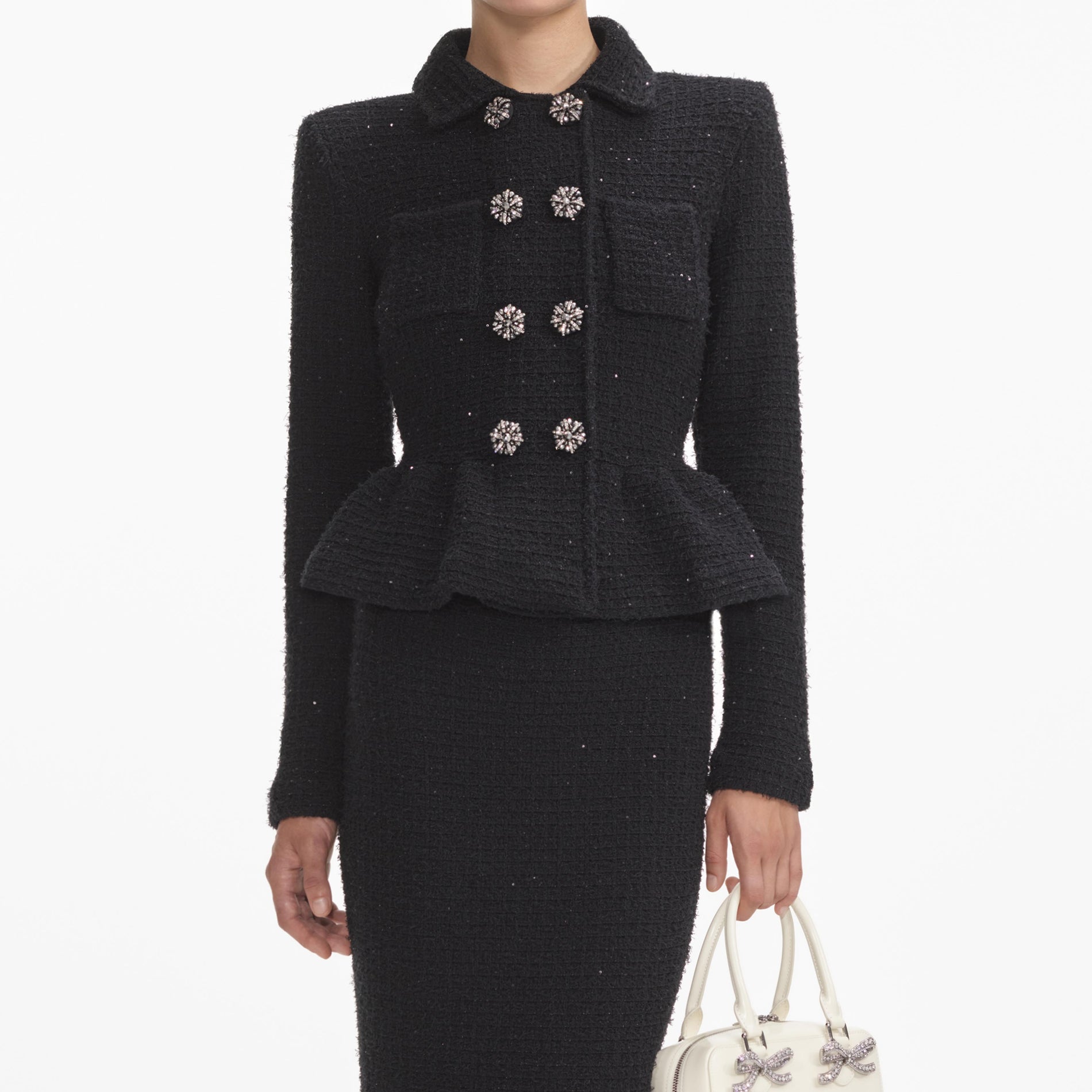 A close up of a woman wearing the Black Textured Knit Peplum Midi Dress