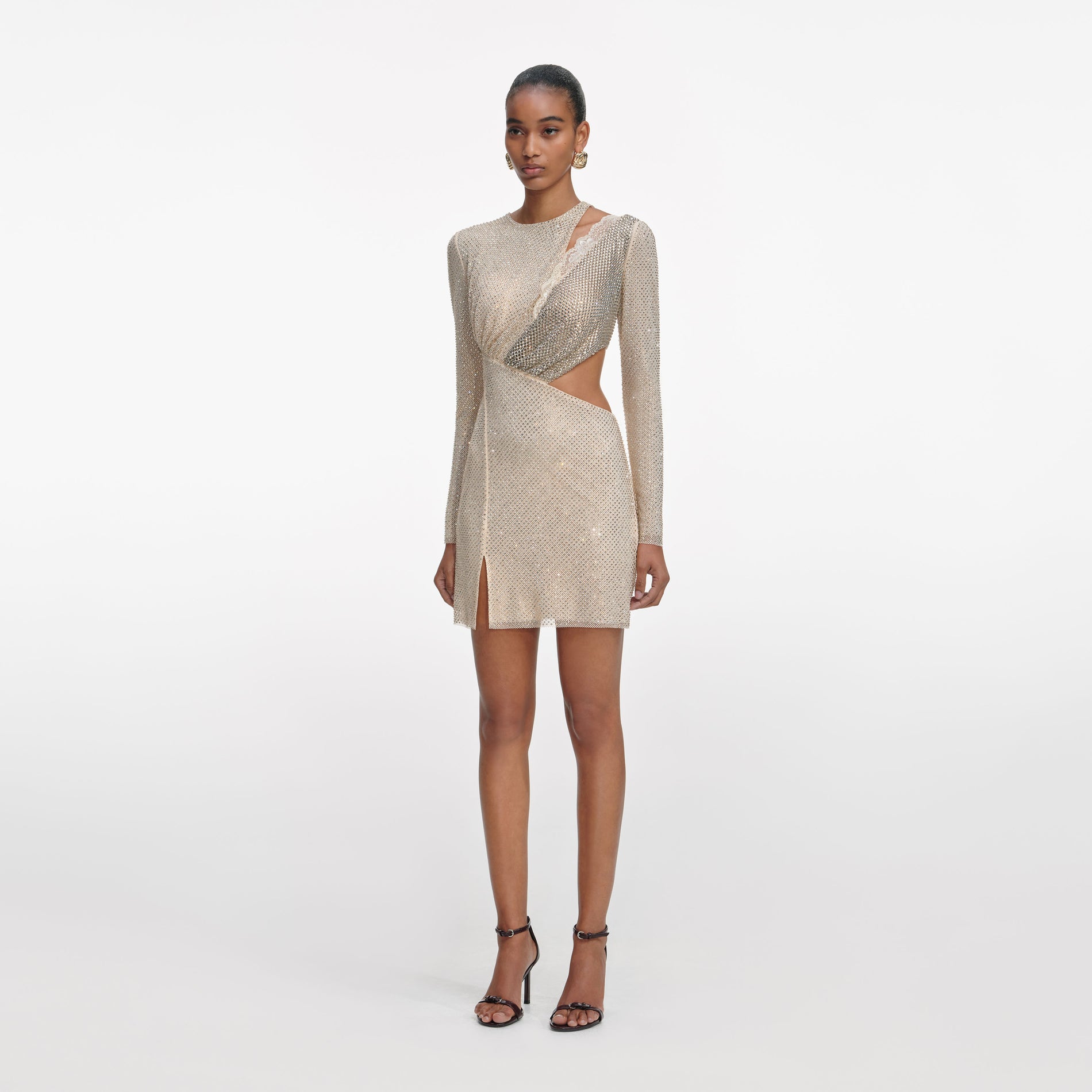 Side view of a woman wearing the Champagne Rhinestone Lace Trim Mini Dress