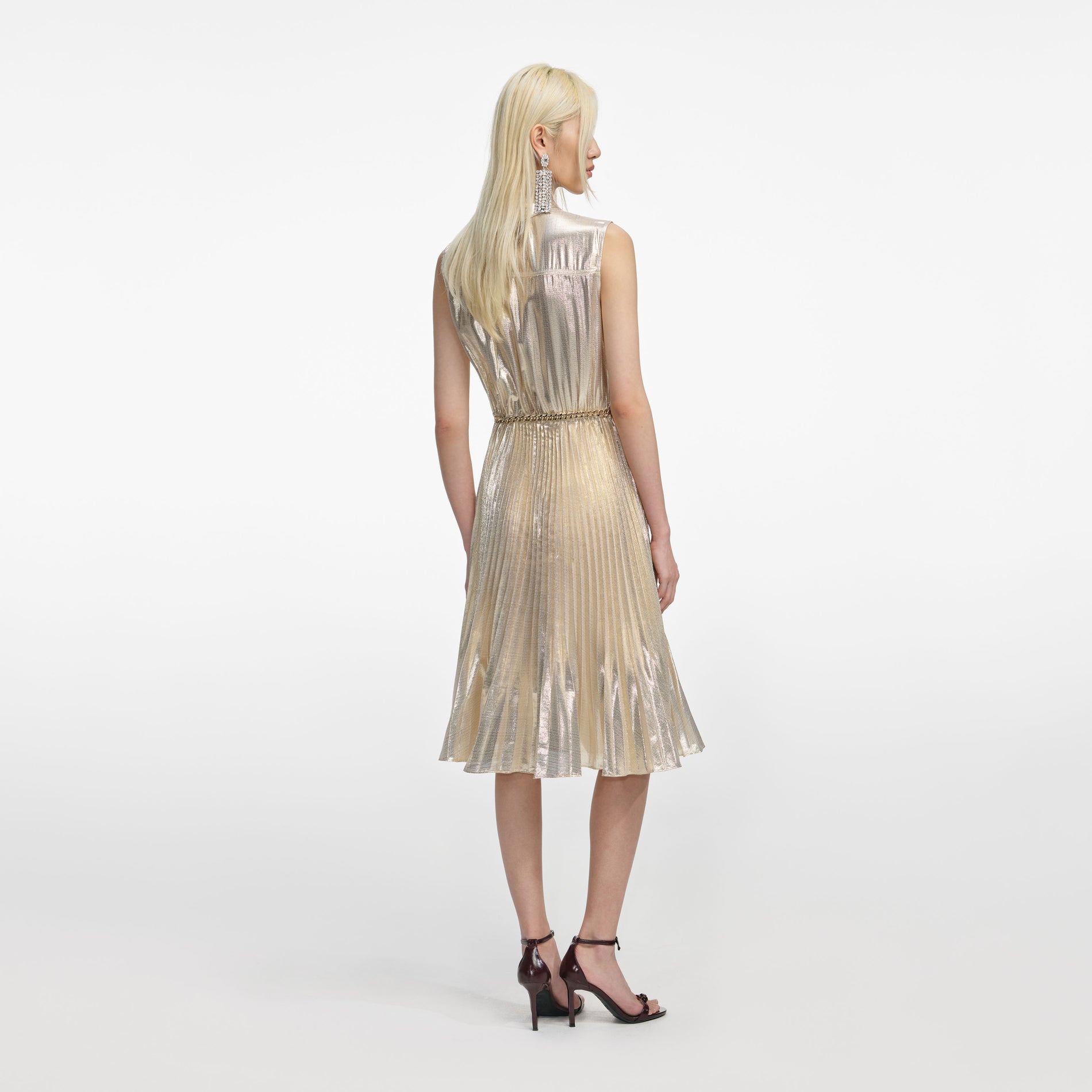 Back view of a woman wearing the Gold Metallic Sleeveless Midi Dress