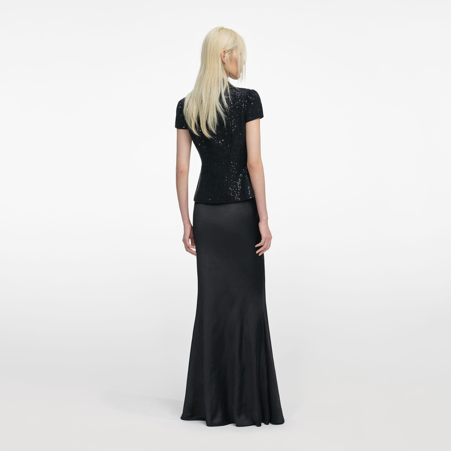Back view of a woman wearing the Black Sequin Boucle Satin Maxi Dress
