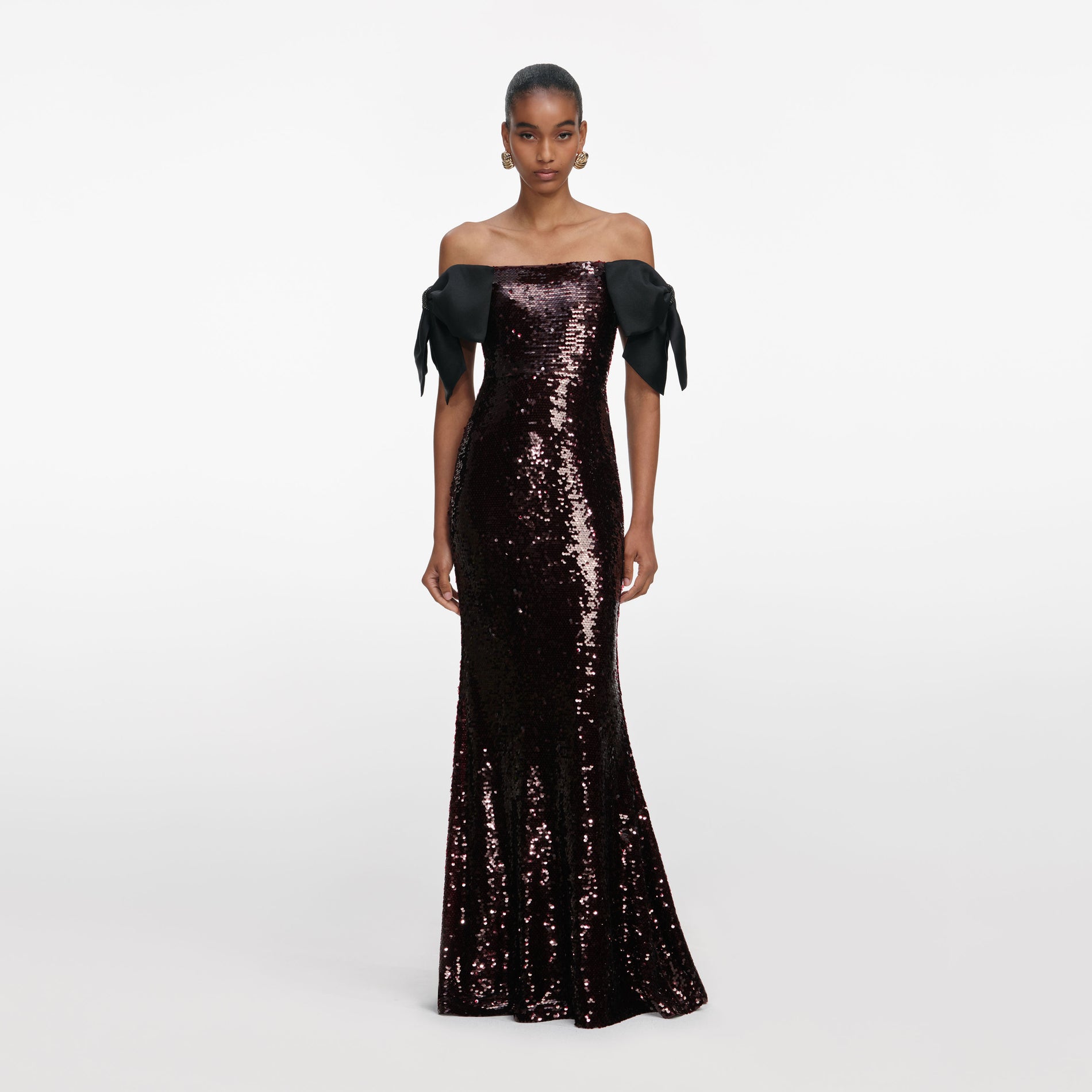 Front view of a woman wearing the Brown Sequin Bow Maxi Dress