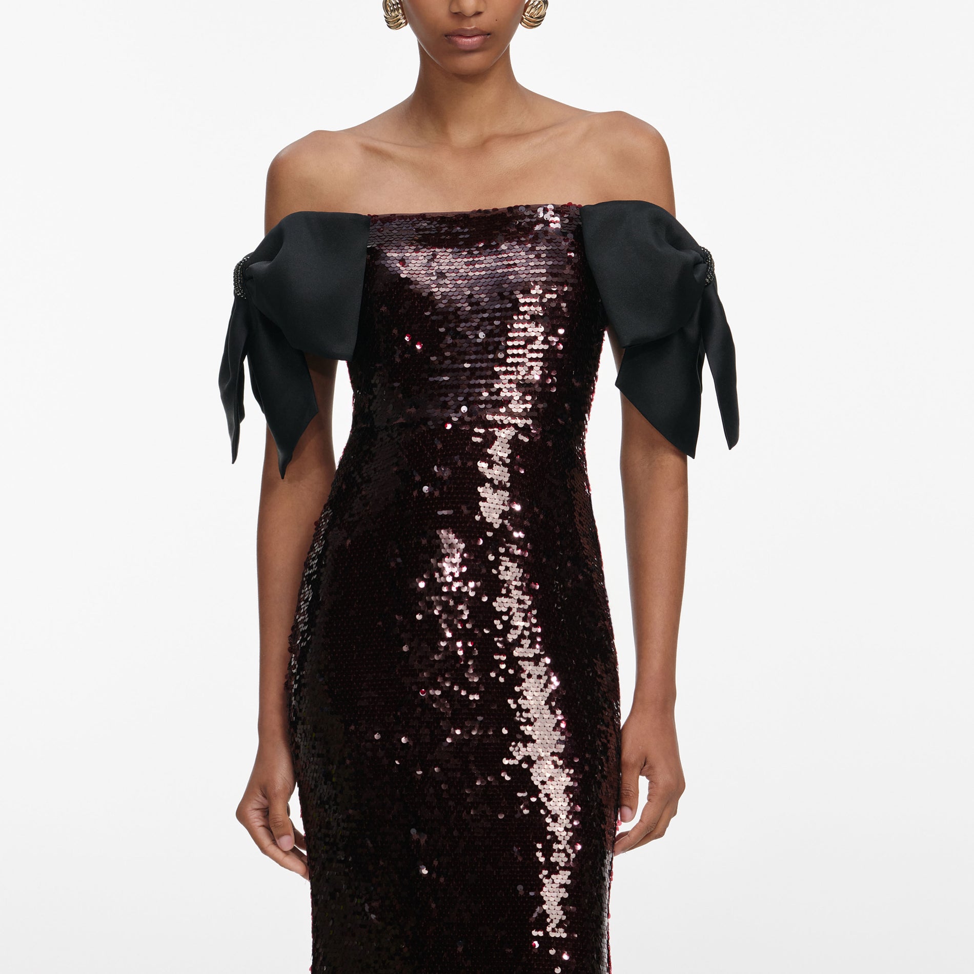 A close up of a woman wearing the Brown Sequin Bow Maxi Dress