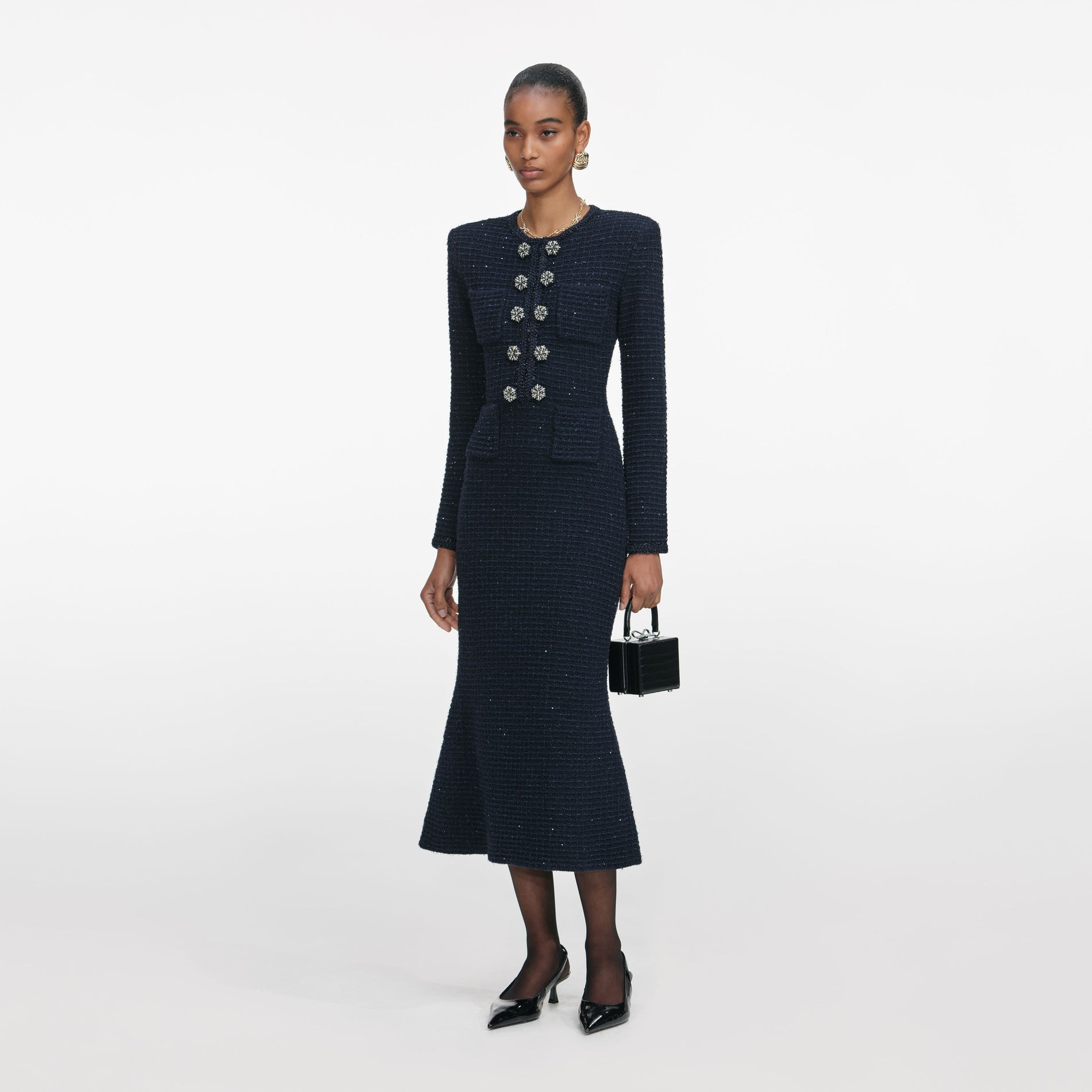 Side view of a woman wearing the Navy Textured Knit Midi Dress
