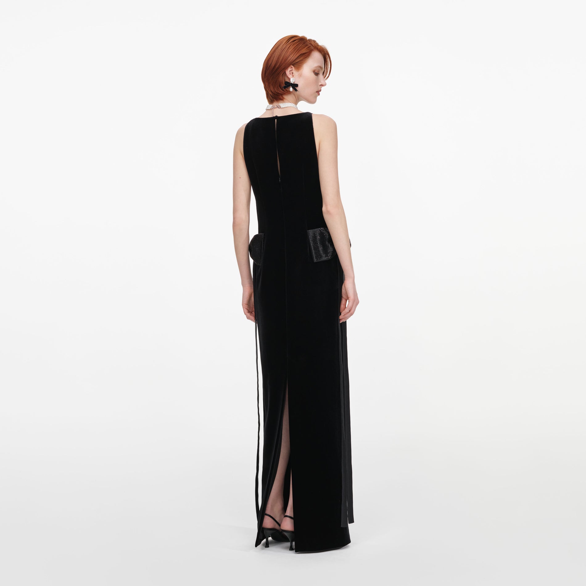 Back view of a woman wearing the Black Velvet Bow Sides Maxi Dress