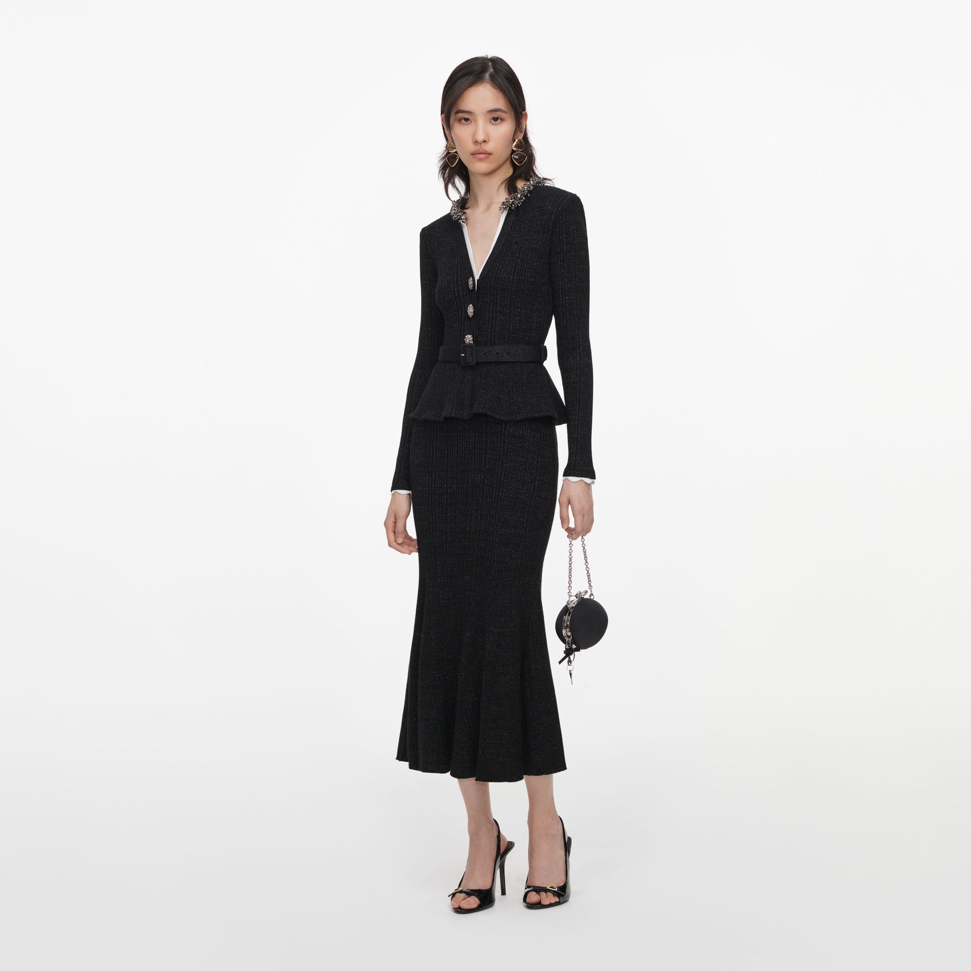 Side view of a woman wearing the Black Lurex Rib Knit Midi Dress