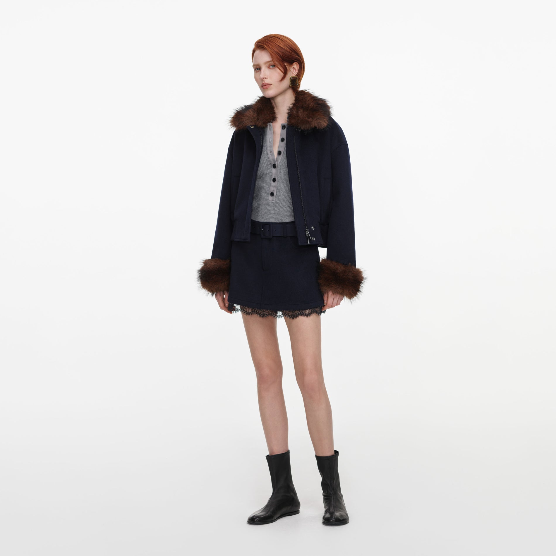 Side view of a woman wearing the Navy Wool Fur Trim Jacket