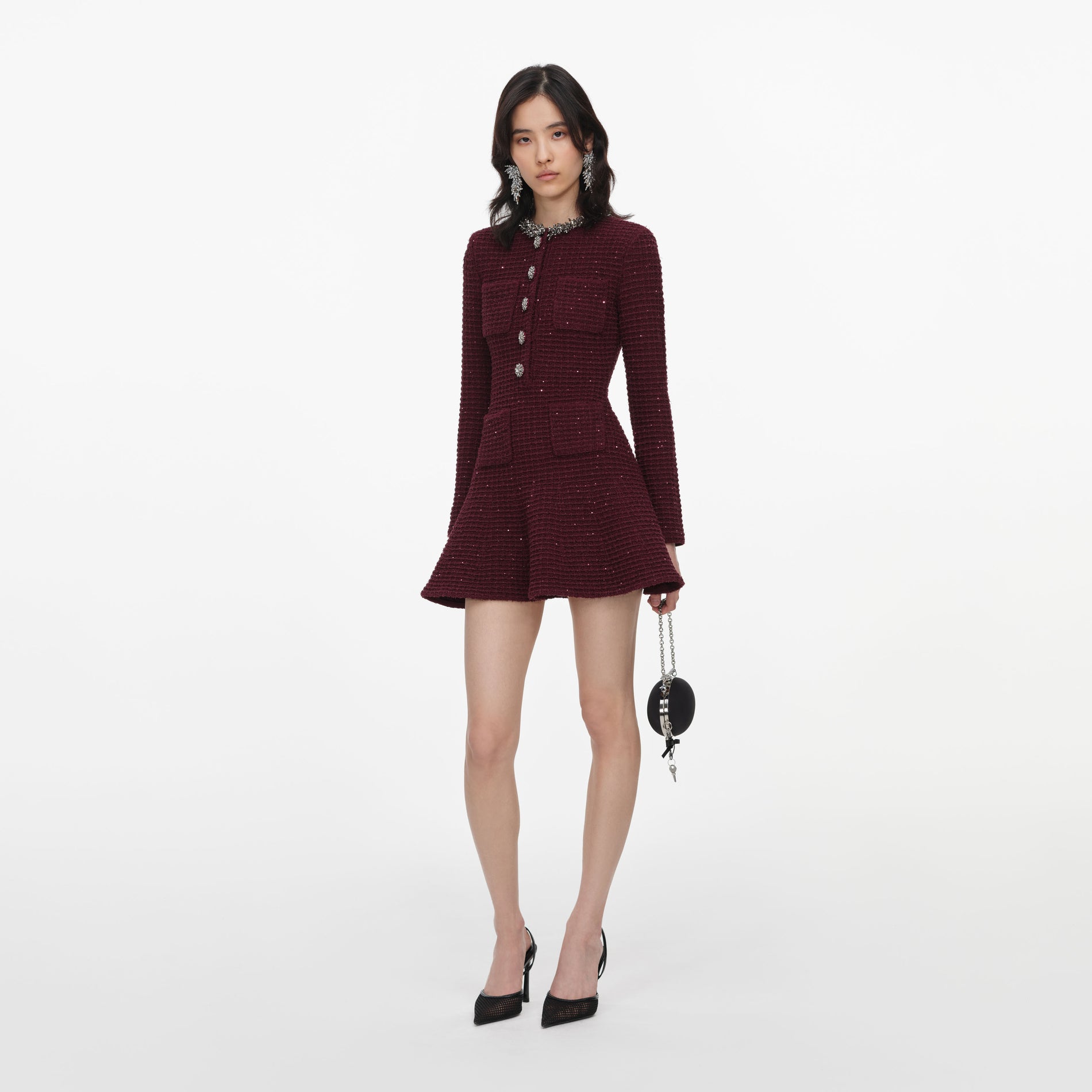 Side view of a woman wearing the Burgundy Textured Knit Embellished Mini Dress
