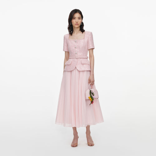 Front view of a woman wearing the Pink Sequin Boucle Midi Dress