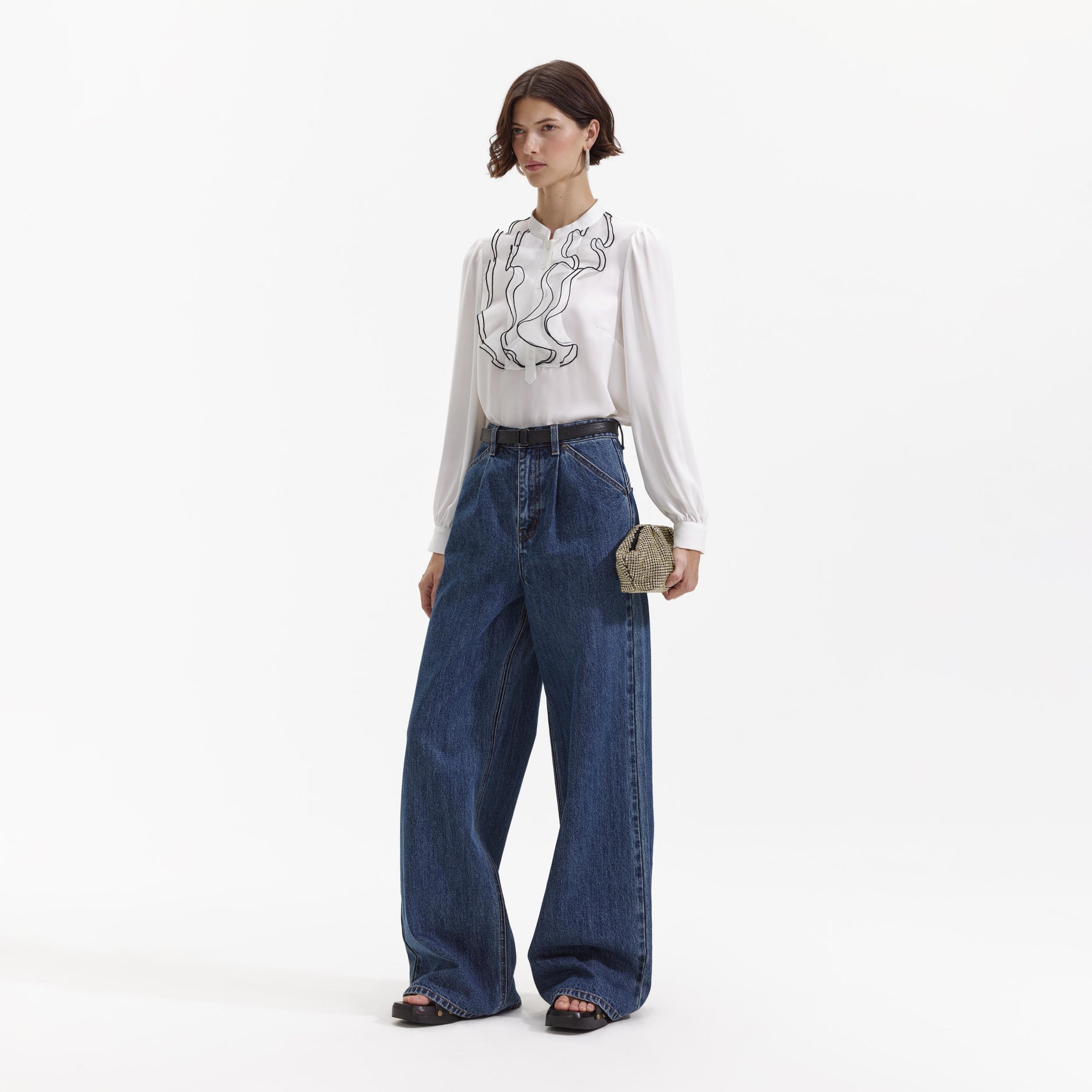 Side view of a woman wearing the Wide Leg Flare Denim Jeans