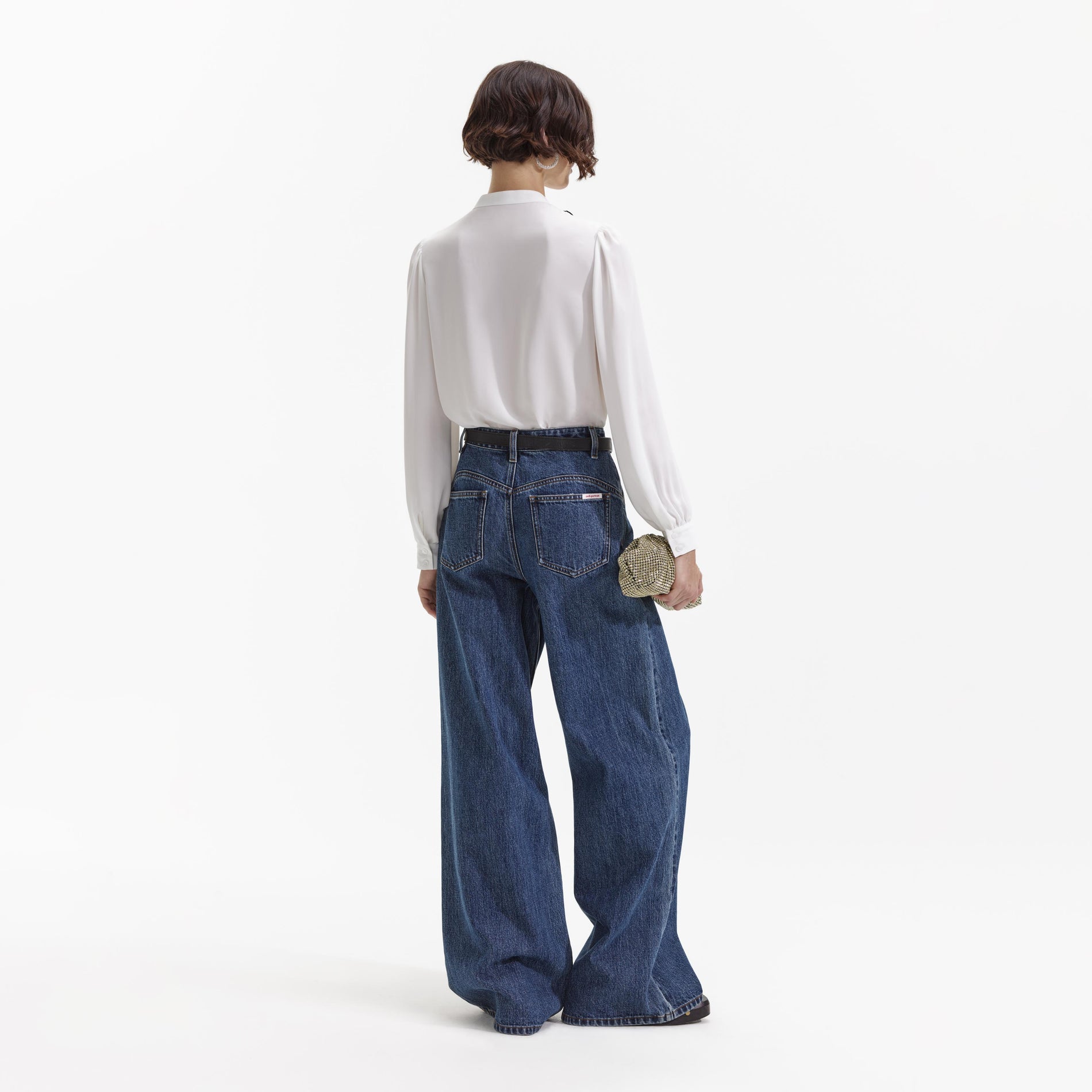 Back view of a woman wearing the Wide Leg Flare Denim Jeans