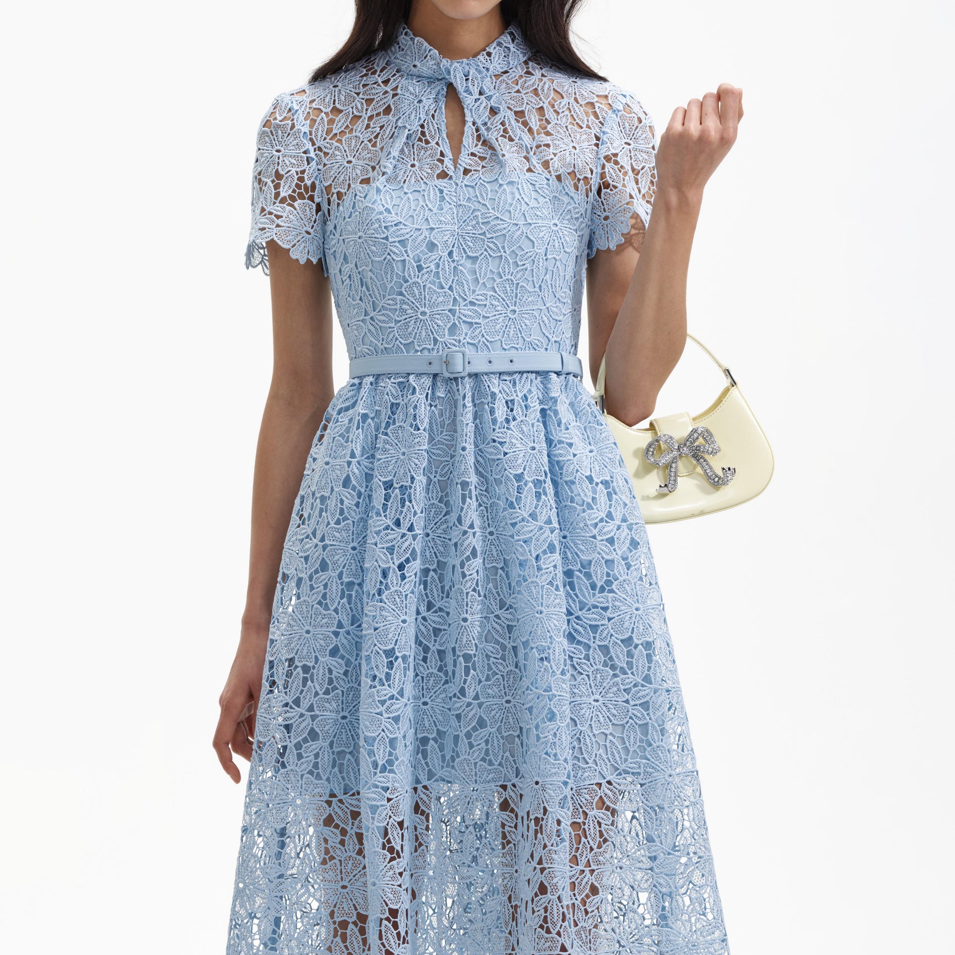 A close up of a woman wearing the Blue Lace Keyhole Midi Dress