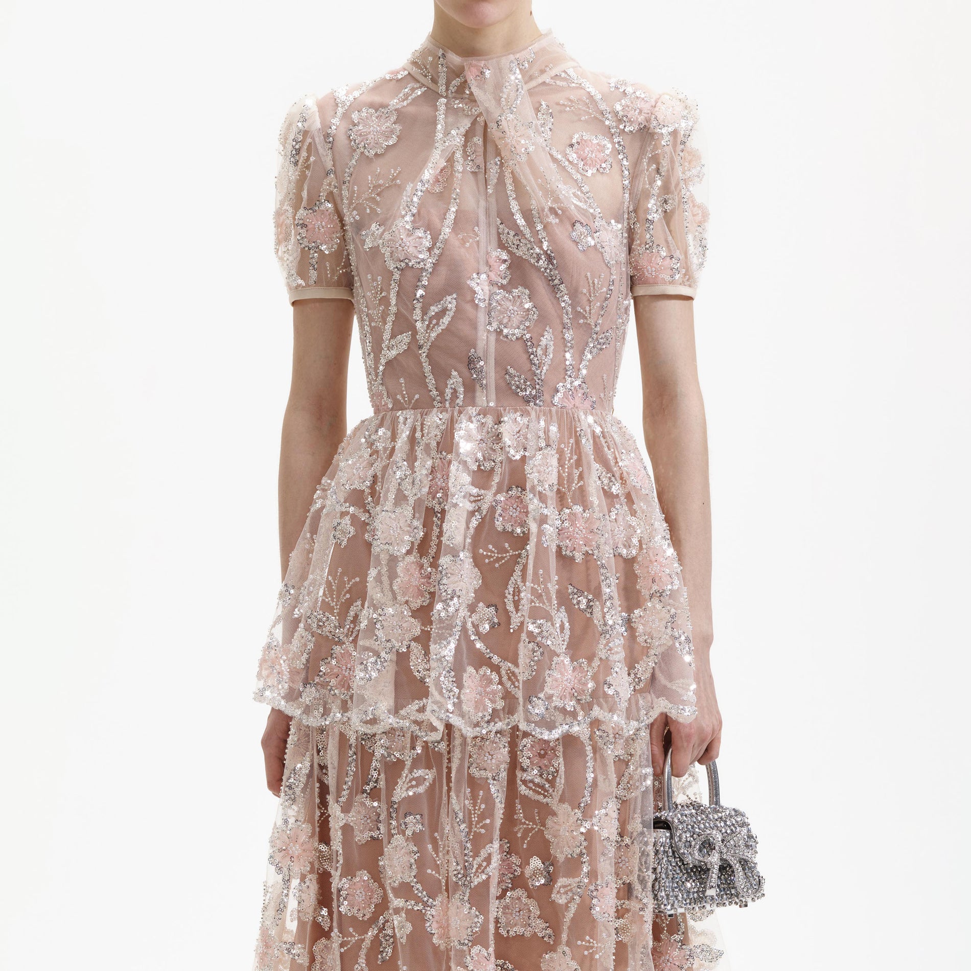 A close up of a woman wearing the Sequin Flower Maxi Dress