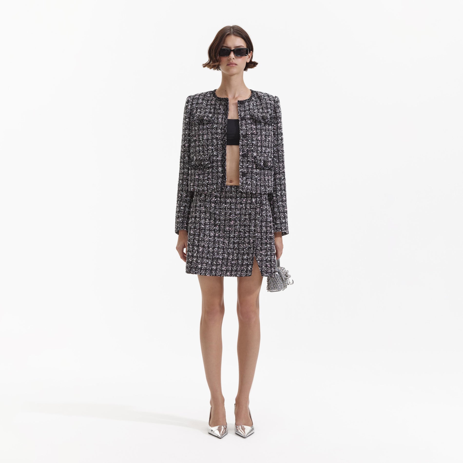 Front view of a woman wearing the Black Check Boucle Mini Skirt