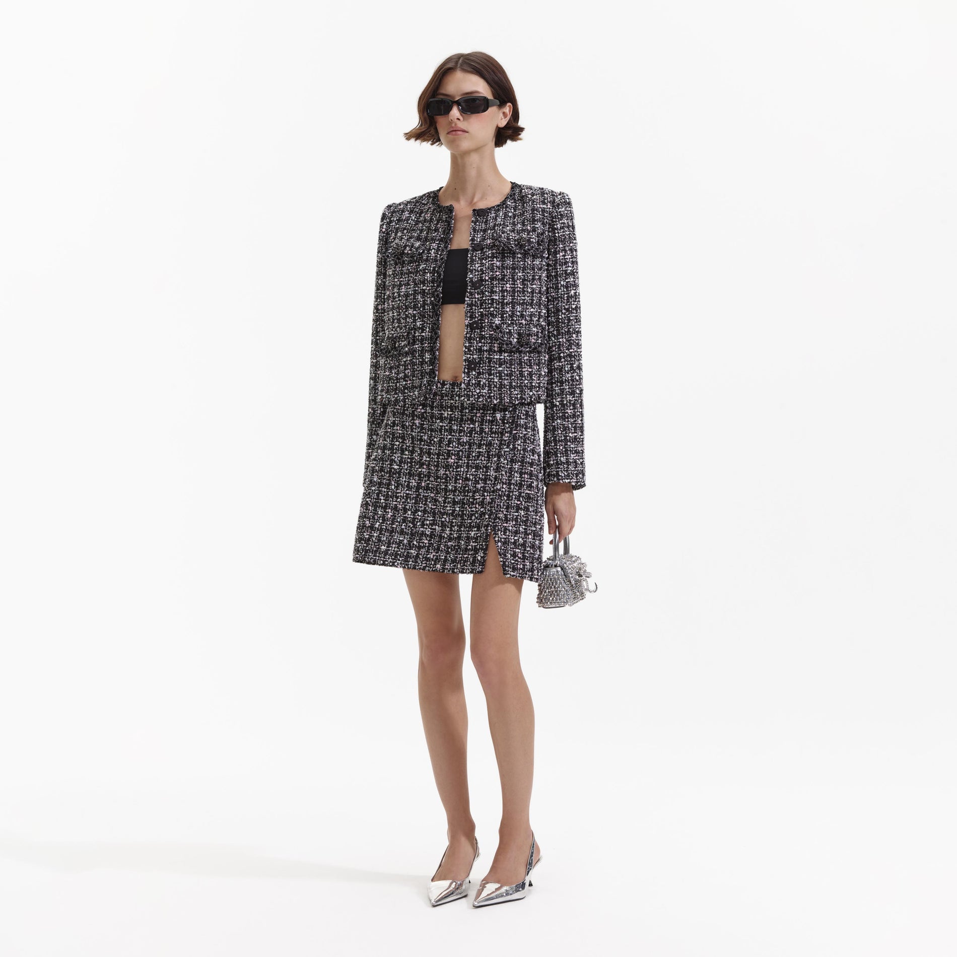 Side view of a woman wearing the Black Check Boucle Mini Skirt