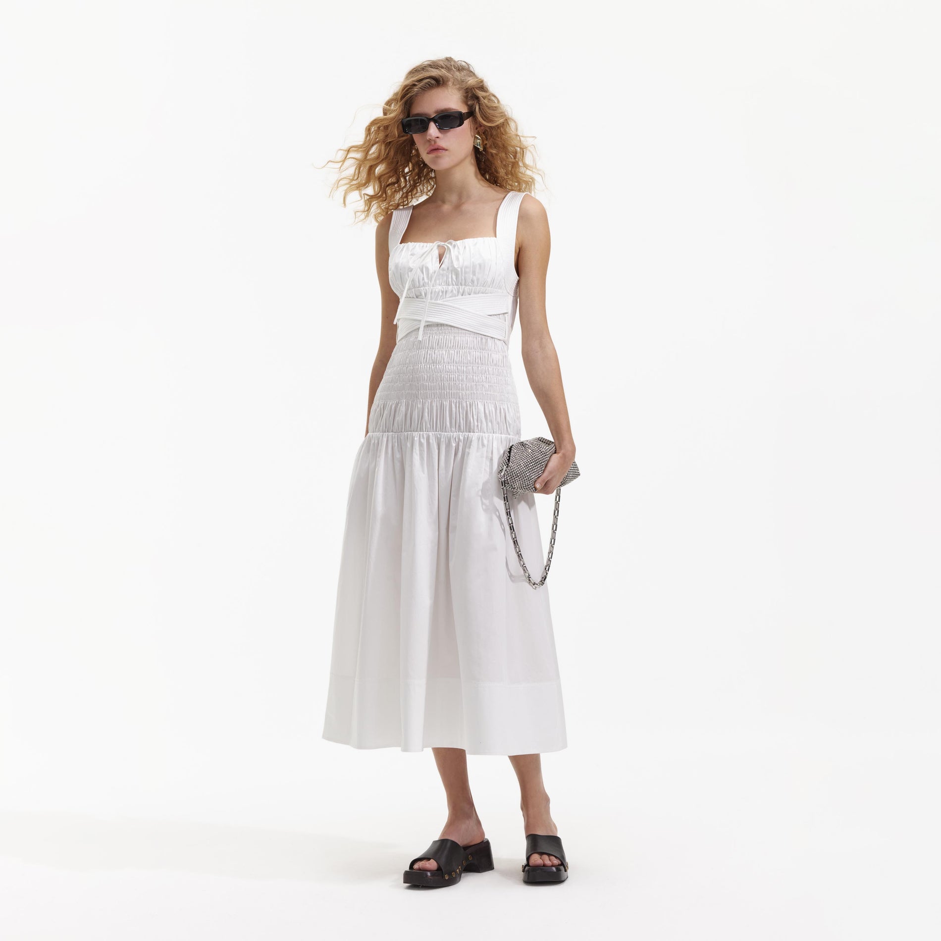 Side view of a woman wearing the White Cotton Sweetheart Midi Dress