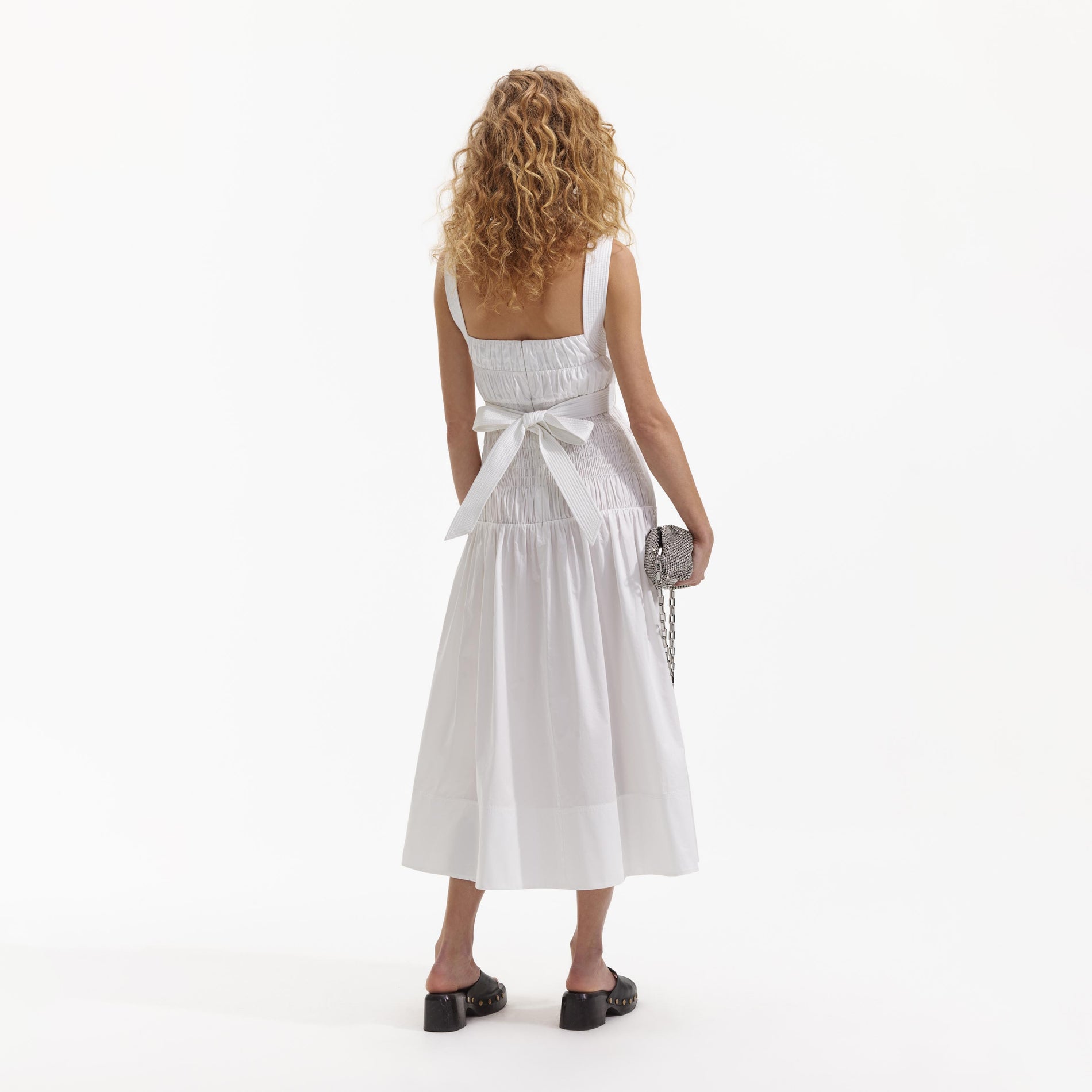 Back view of a woman wearing the White Cotton Sweetheart Midi Dress