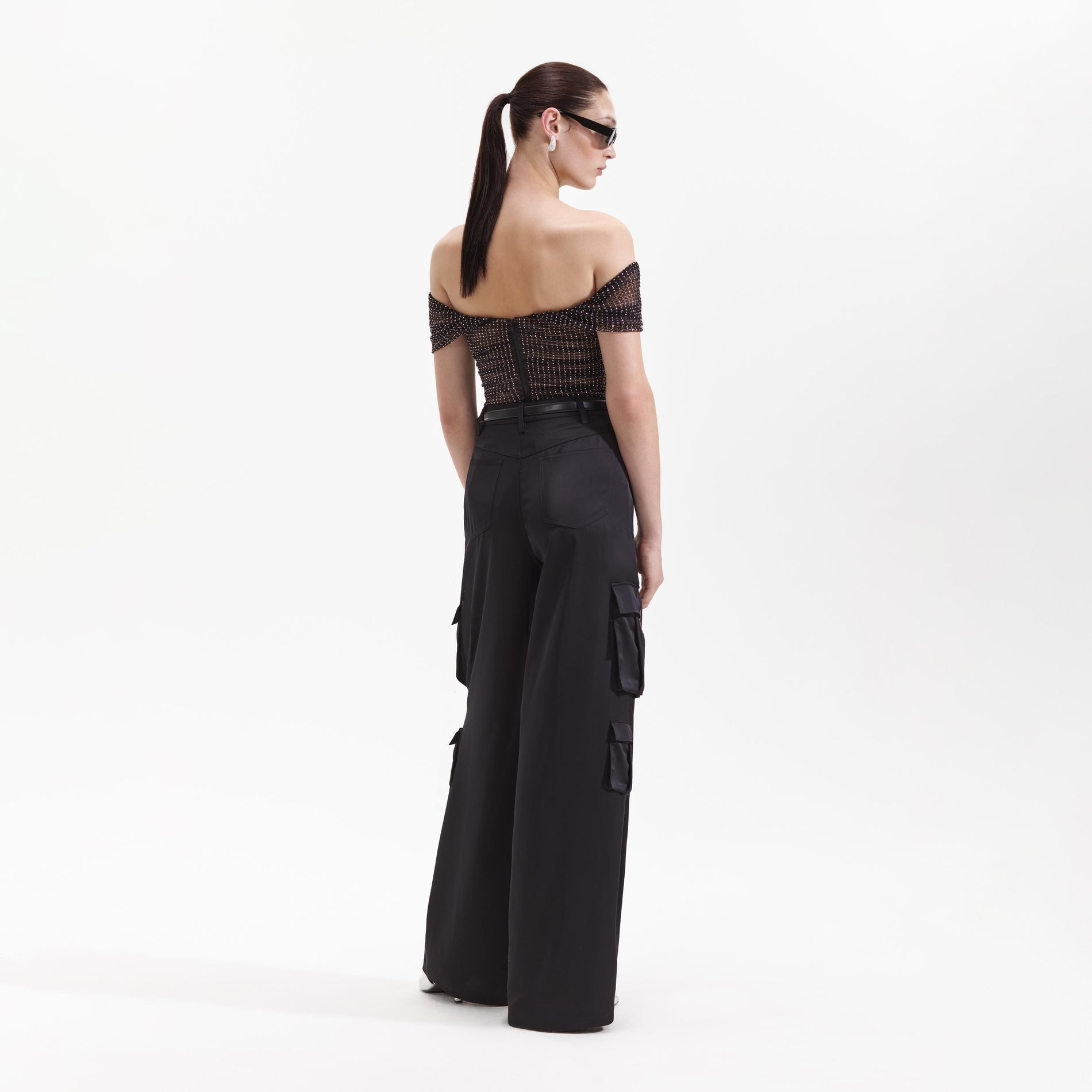Back view of a woman wearing the Black Satin Cargo Trouser