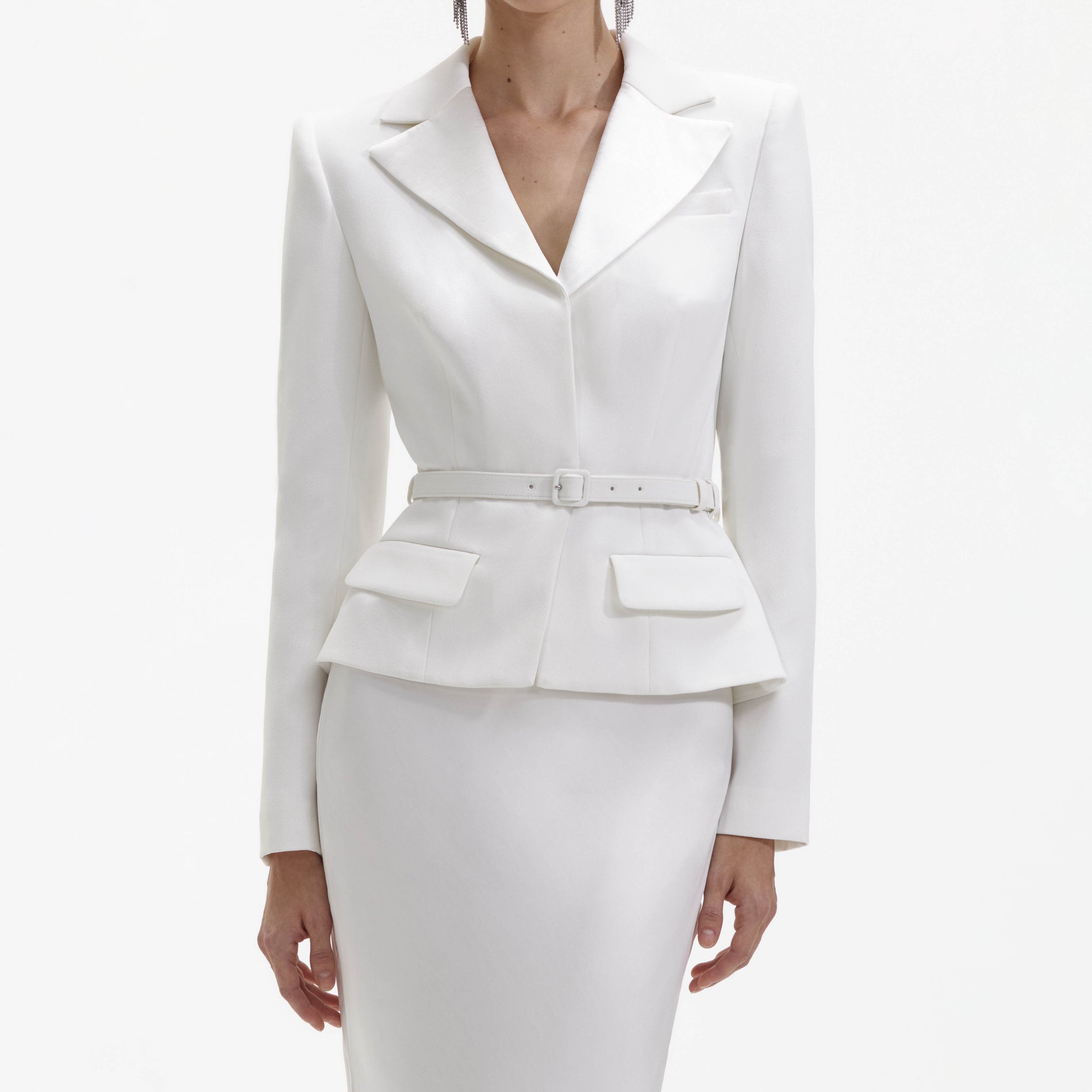 A close up of a woman wearing the White Crepe Tailored Maxi Dress