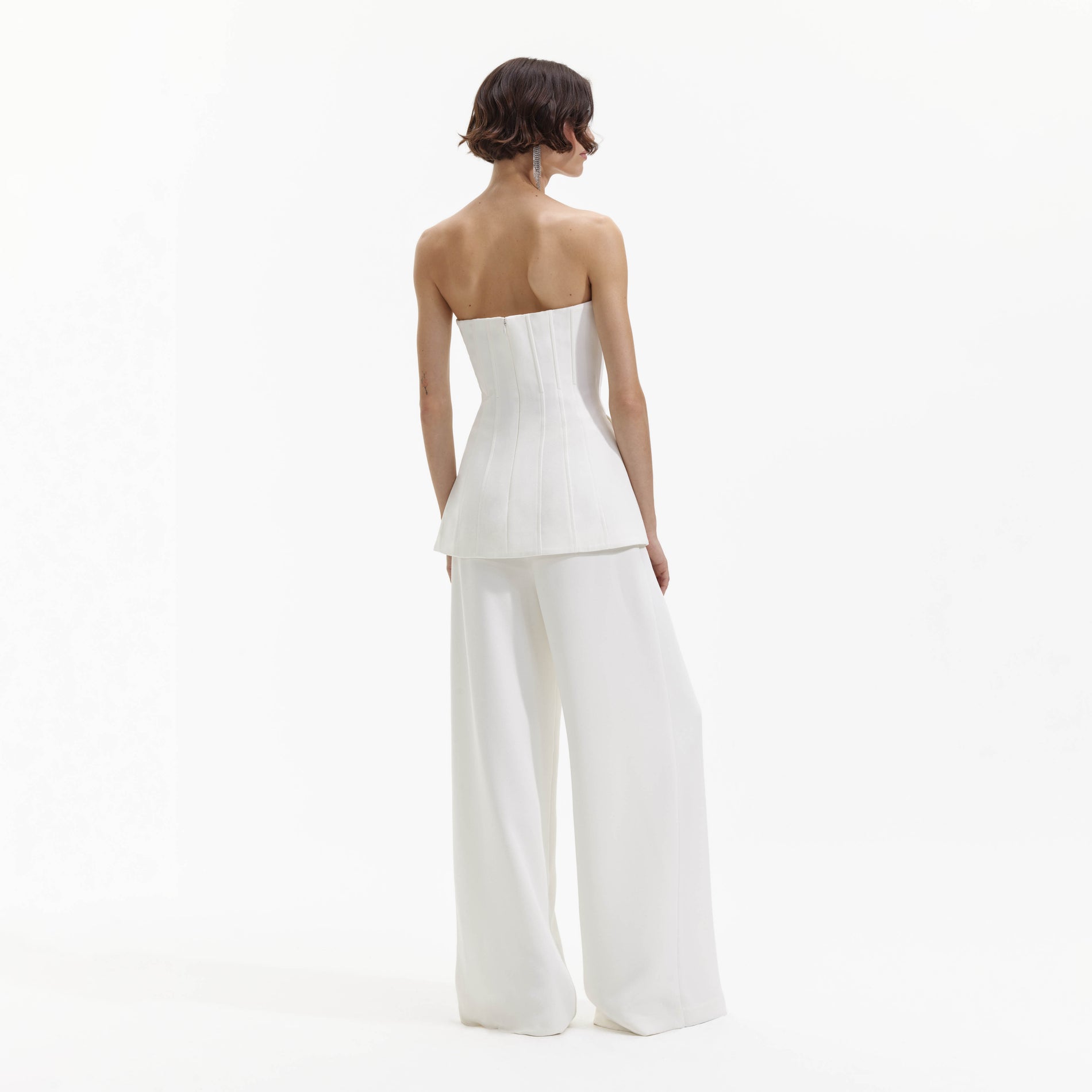 Back view of a woman wearing the White Bandeau Crepe Jumpsuit