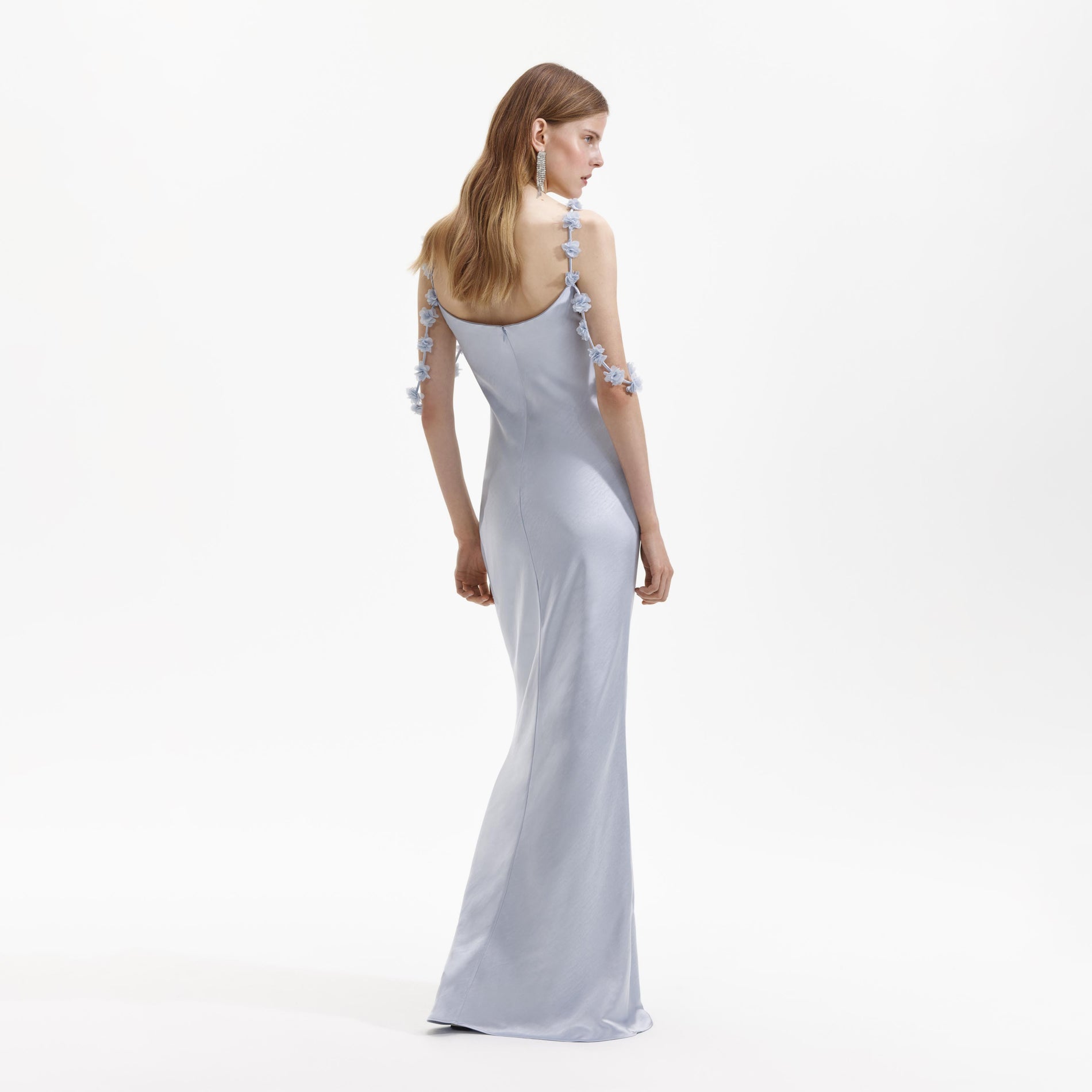 Back view of a woman wearing the Blue Satin Flower Maxi Dress