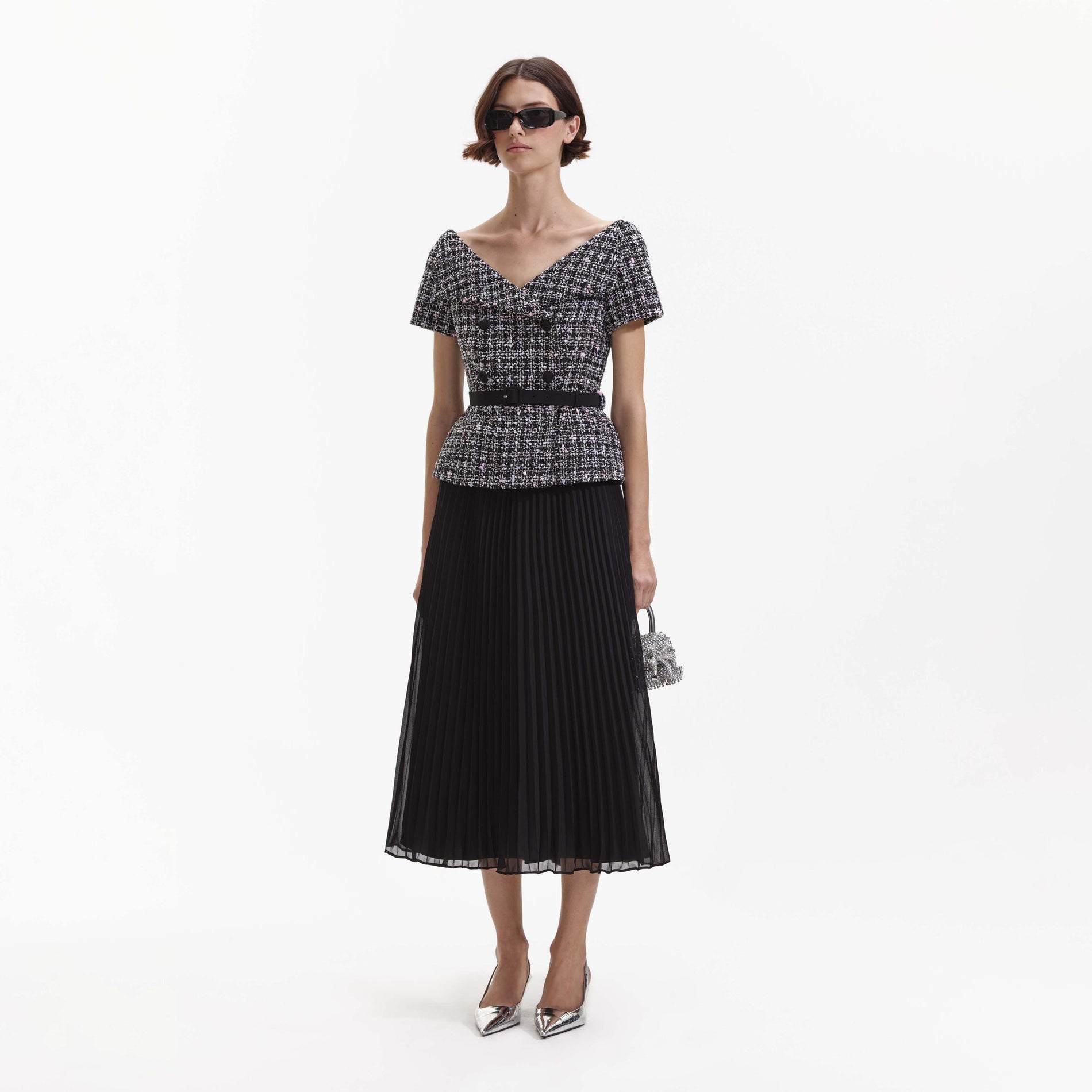 Side view of a woman wearing the Black Boucle Off Shoulder Midi Dress