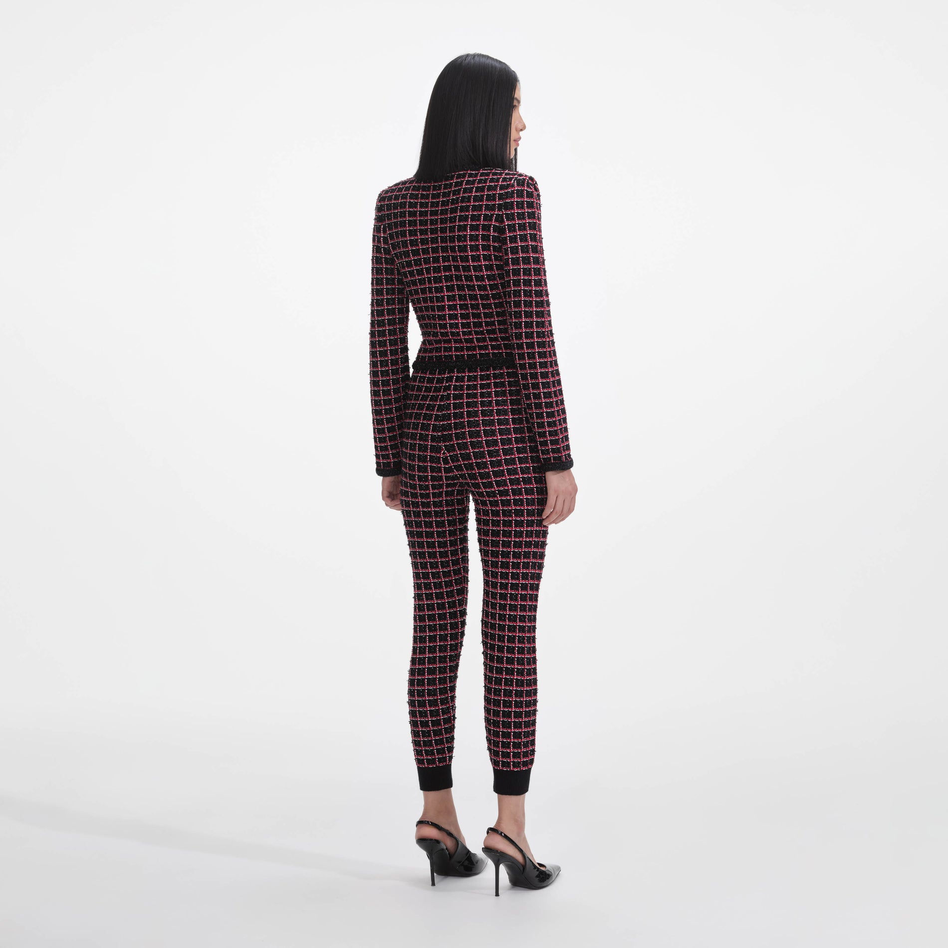 Back view of a woman wearing the Black And Red Check Knit Leggings