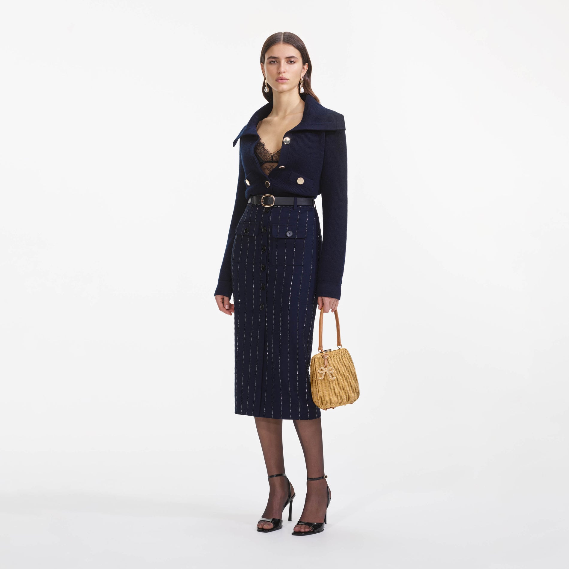 Side view of a woman wearing the Navy Relaxed Fit Cardigan