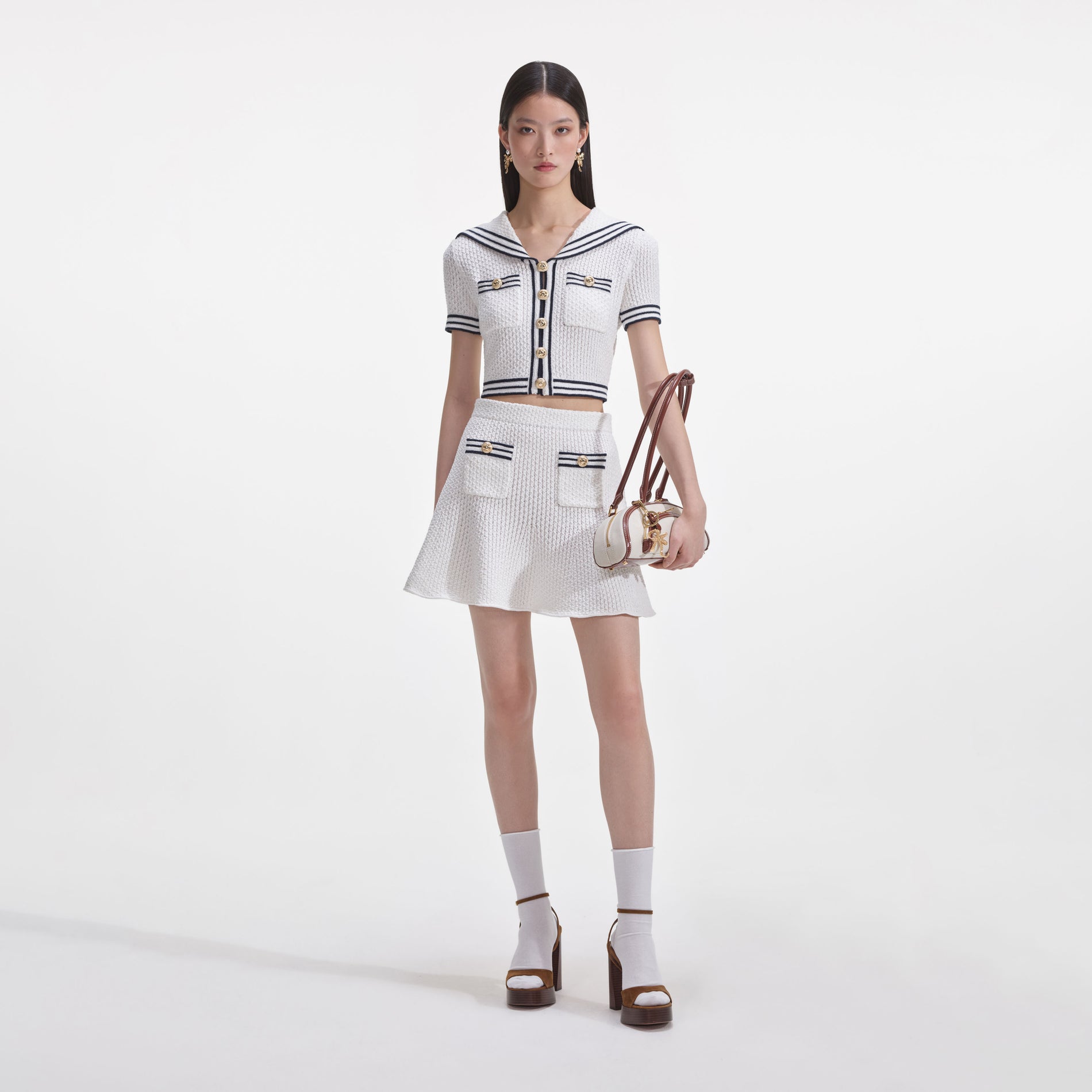 Front view of a woman wearing the White Textured Knit Top