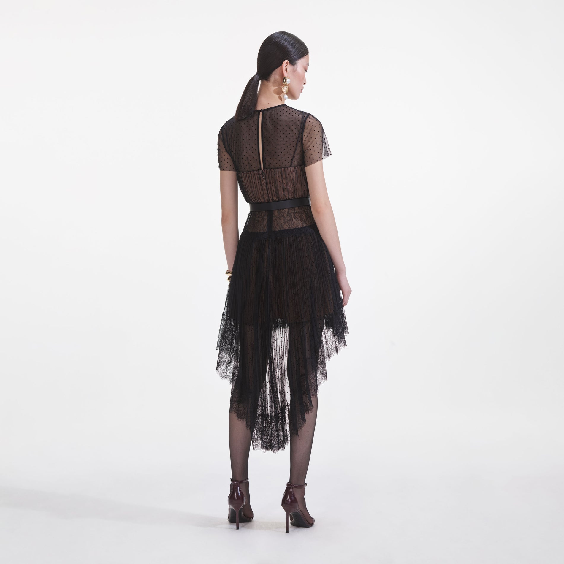 Back view of a woman wearing the Black Dot Mesh Mini Dress