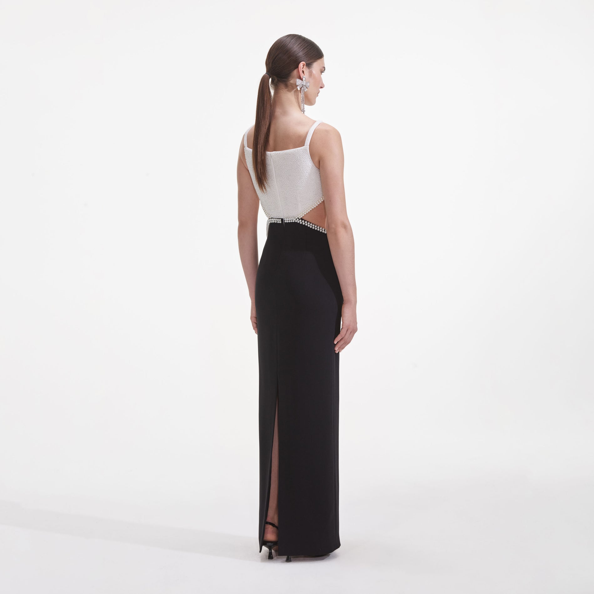 Back view of a woman wearing the Black And White Crepe Maxi Dress