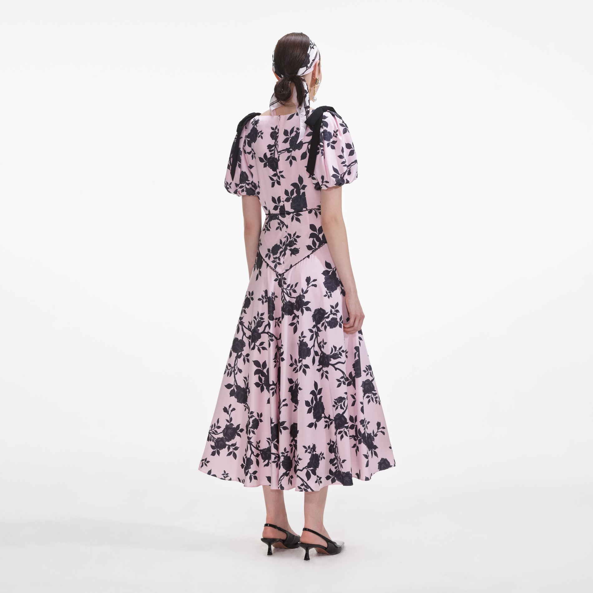 Back view of a woman wearing the Pink Satin Floral Midi Dress