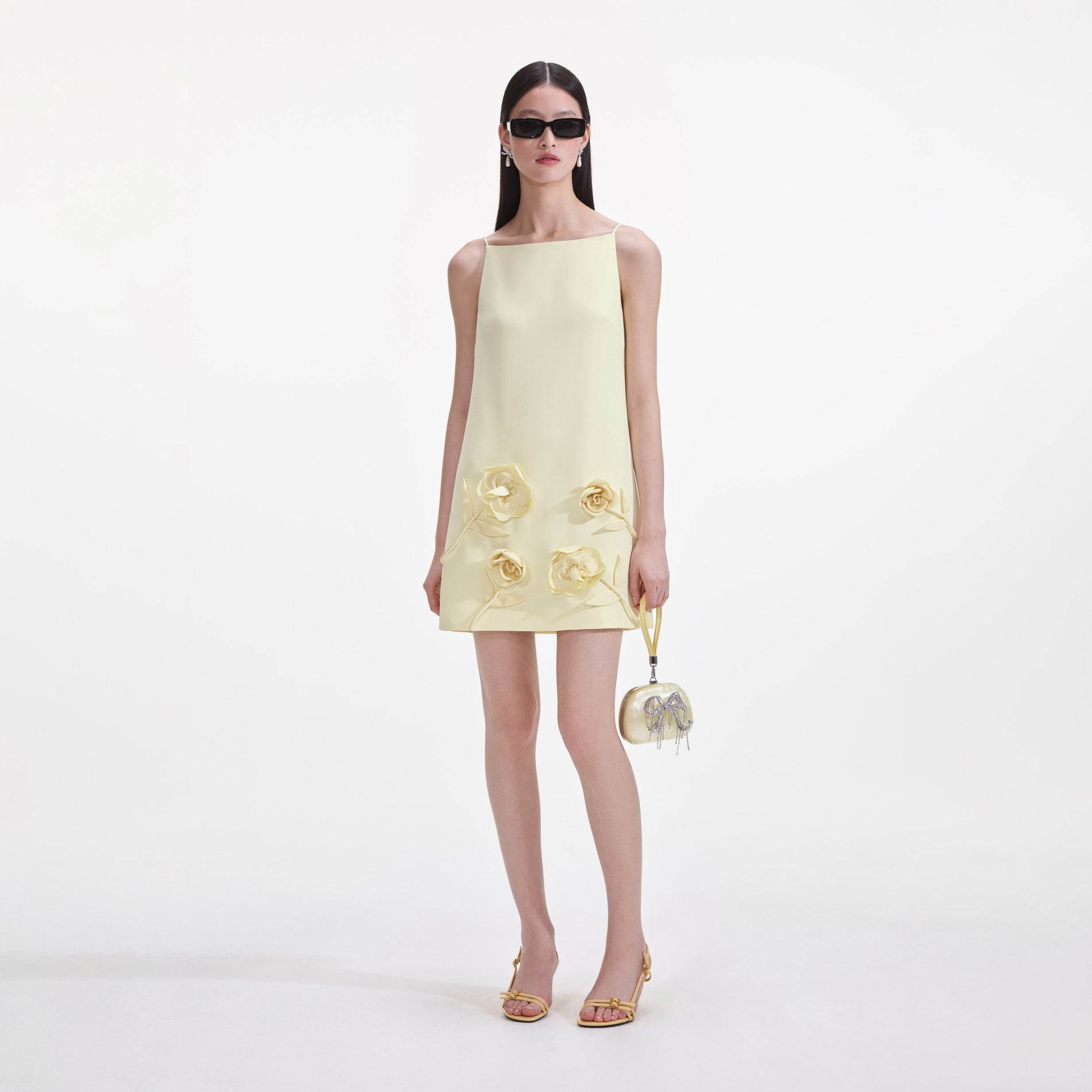 Front view of a woman wearing the Yellow Crepe Flower Mini Dress