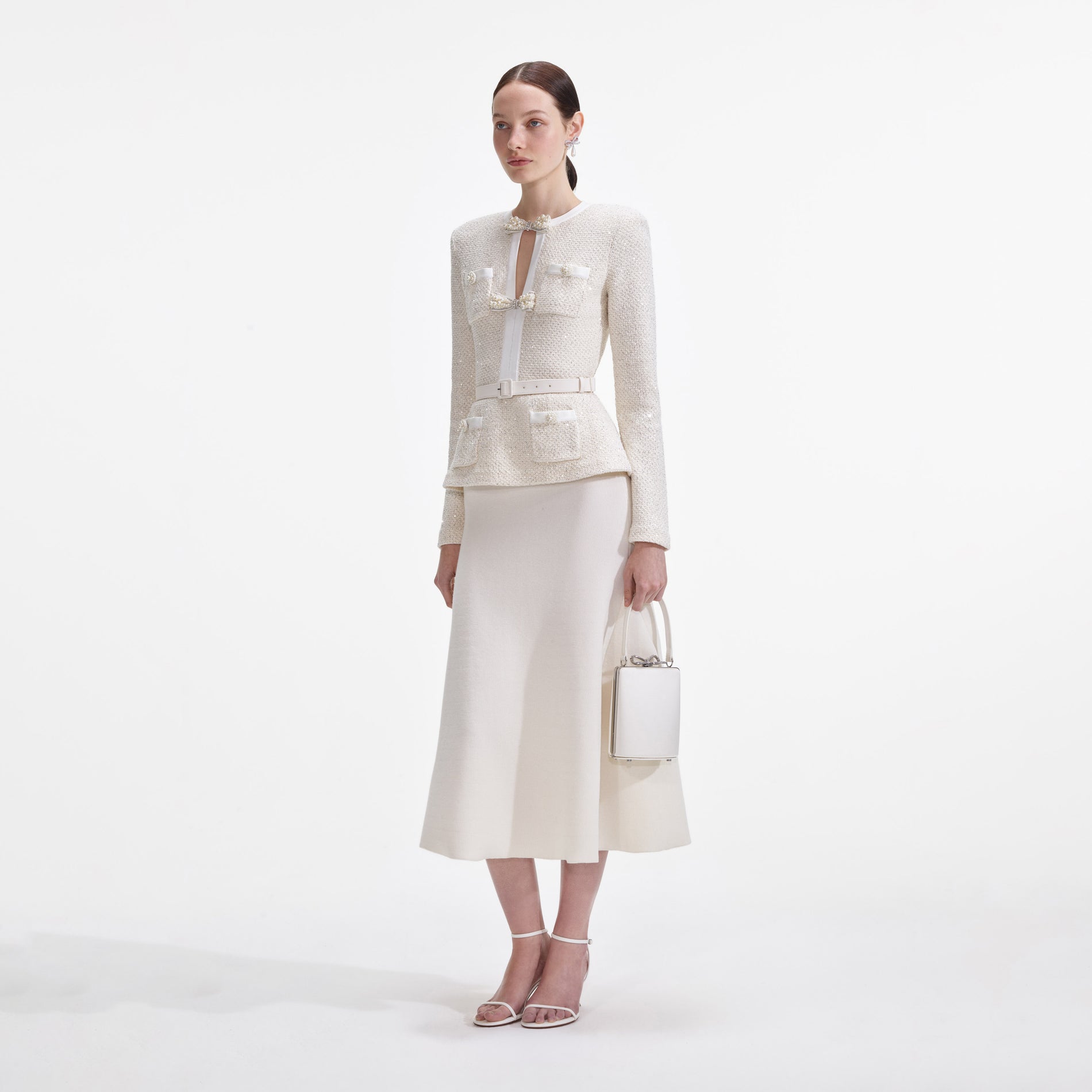 Side view of a woman wearing the Cream Sequin Knit Tailored Midi Dress