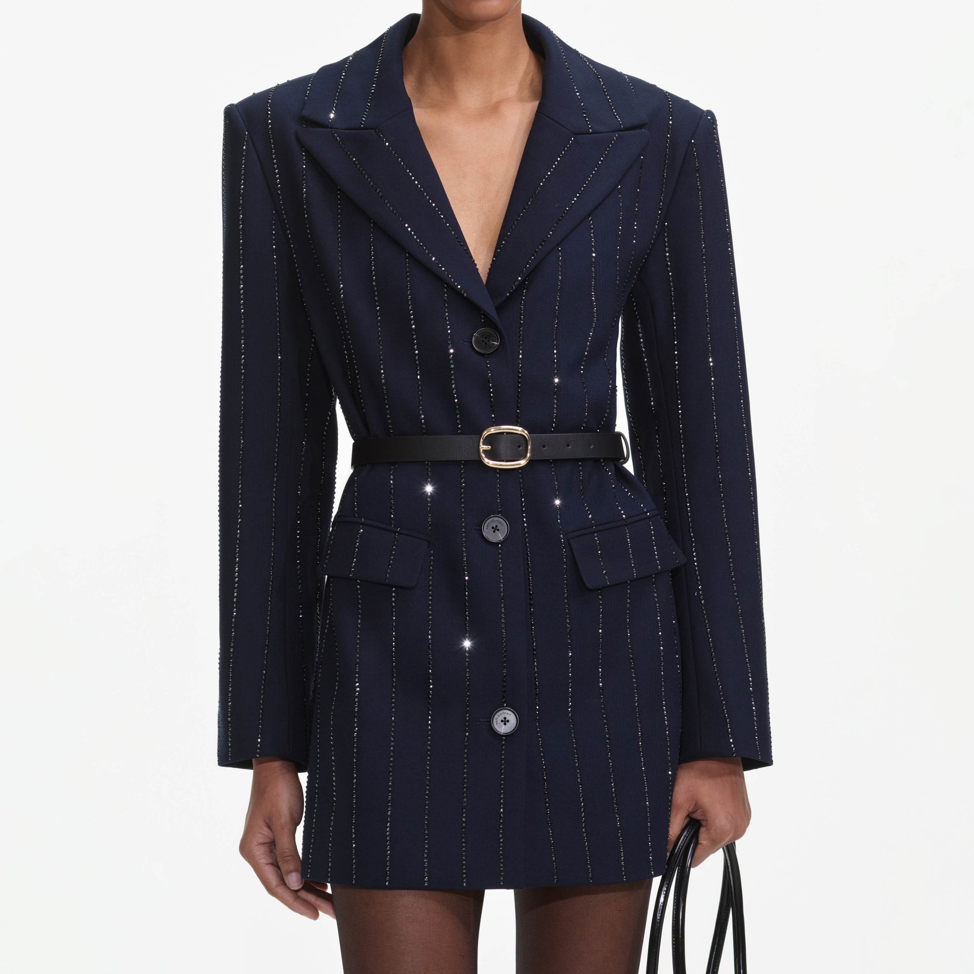 A close up of a woman wearing the Navy Rhinestone Pinstripe Blazer