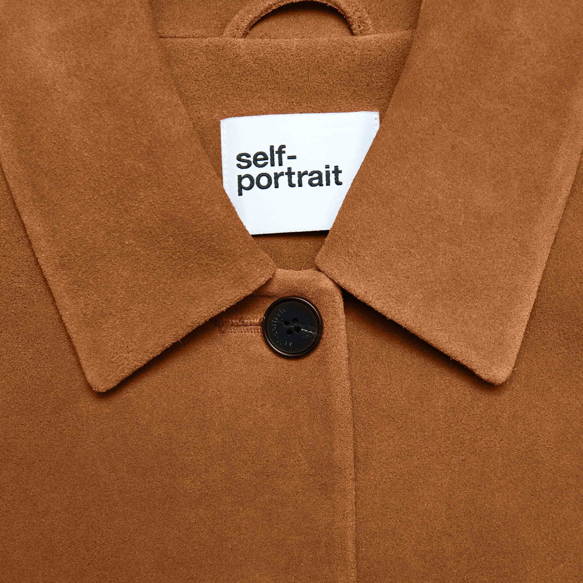 Side view of a woman wearing the Brown Suede Jacket