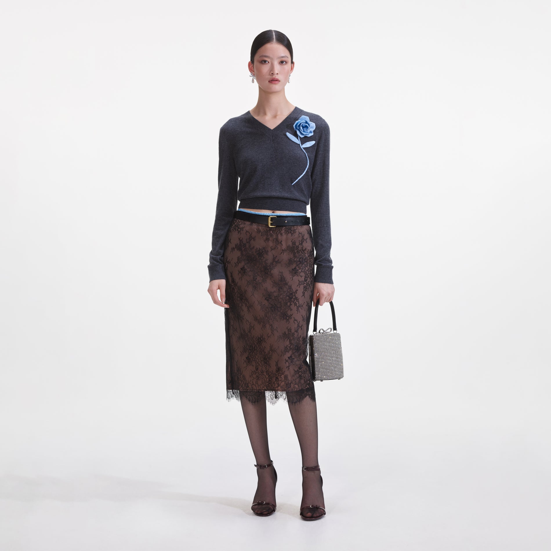 Front view of a woman wearing the Black Lace Midi Skirt