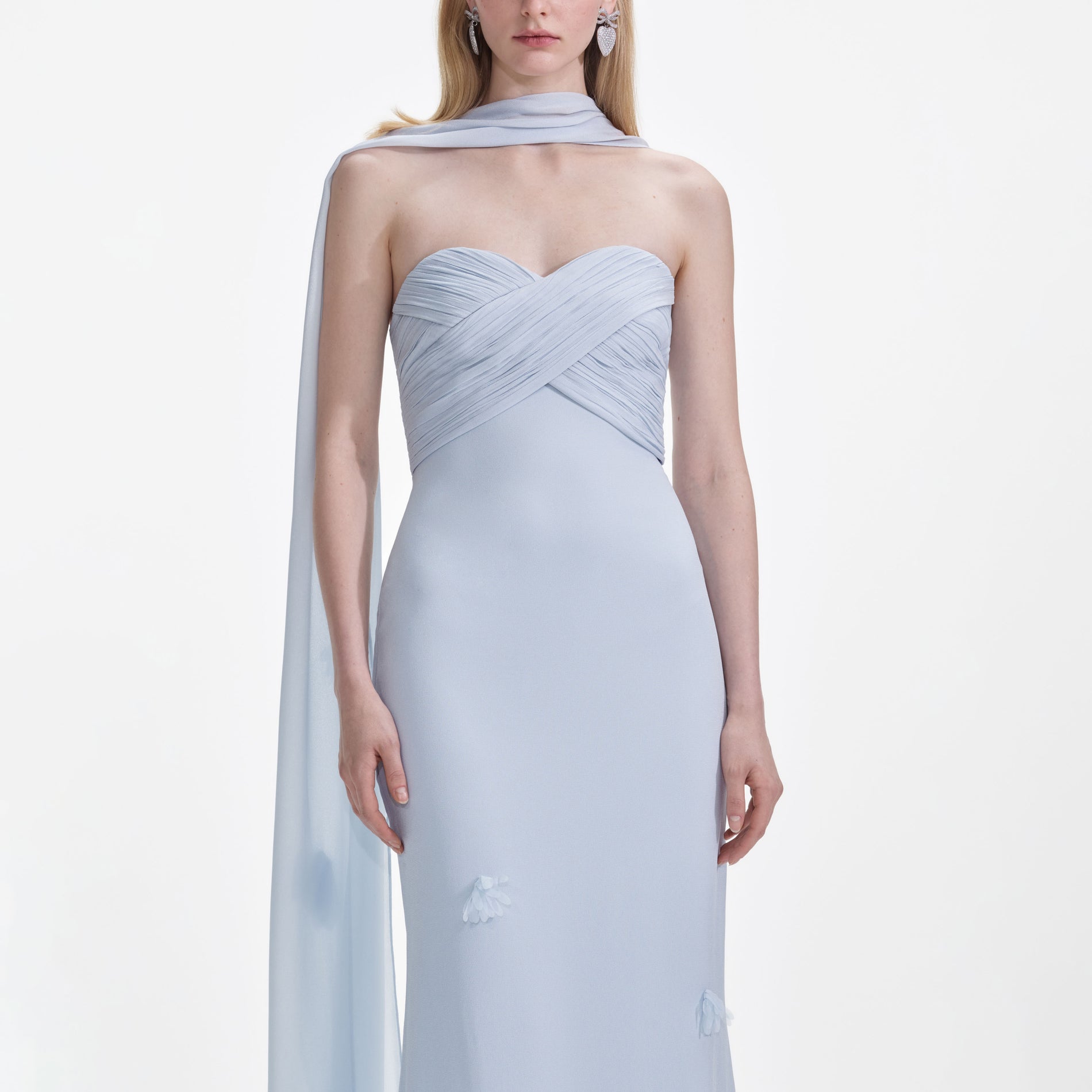 A close up of a woman wearing the Blue Georgette Flower Maxi Dress