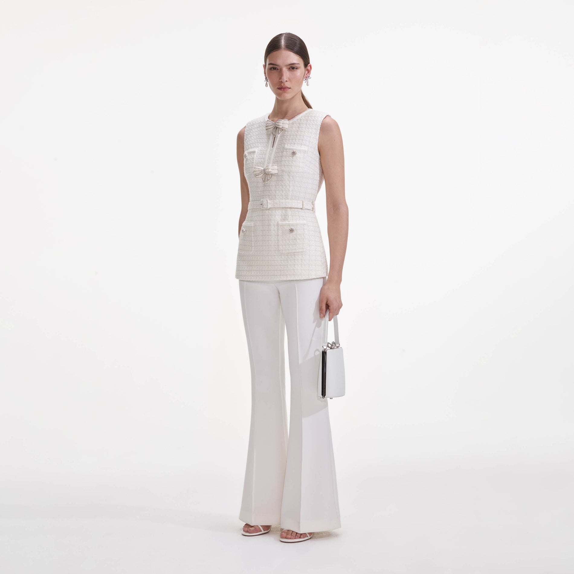 Side view of a woman wearing the Cream Boucle Bow Jumpsuit