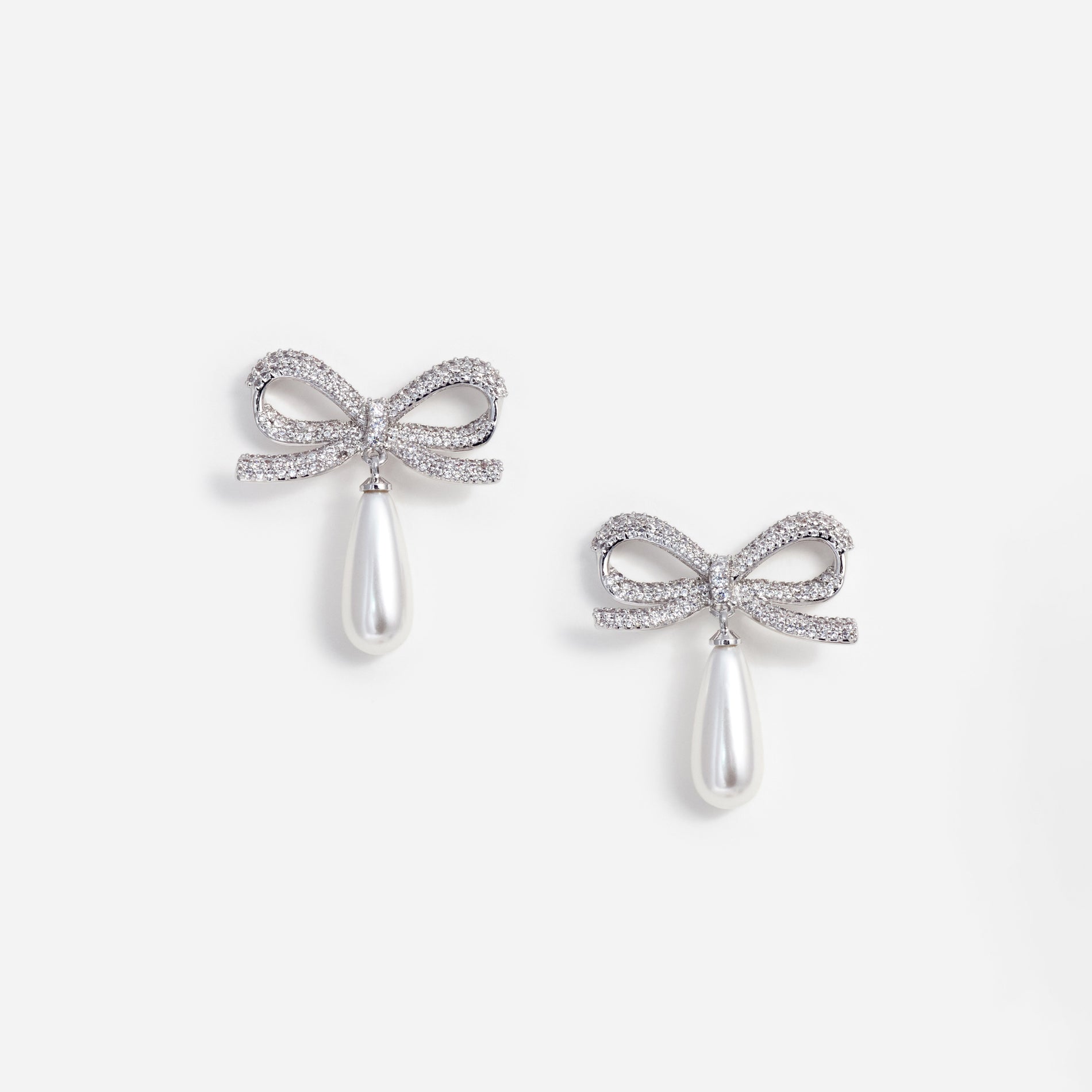 A photo of the Crystal Bow Pearl Droplet Earrings
