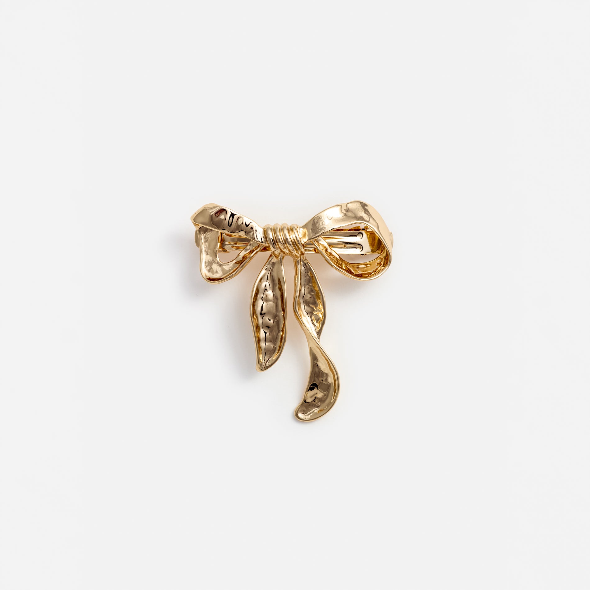 A photo of the Mottled Gold Bow Hairclip