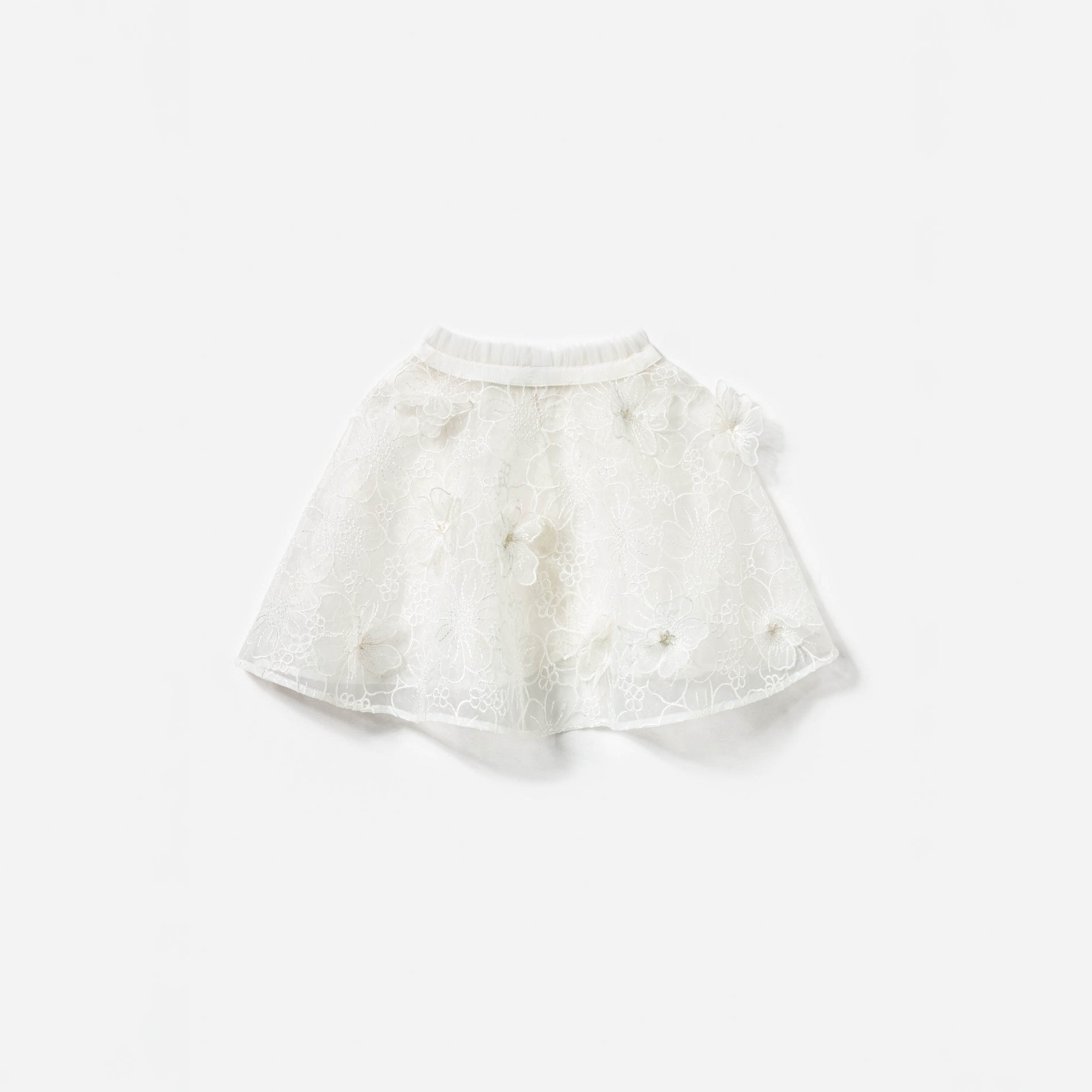 Side view of a woman wearing the White Embellished Tulle Cape