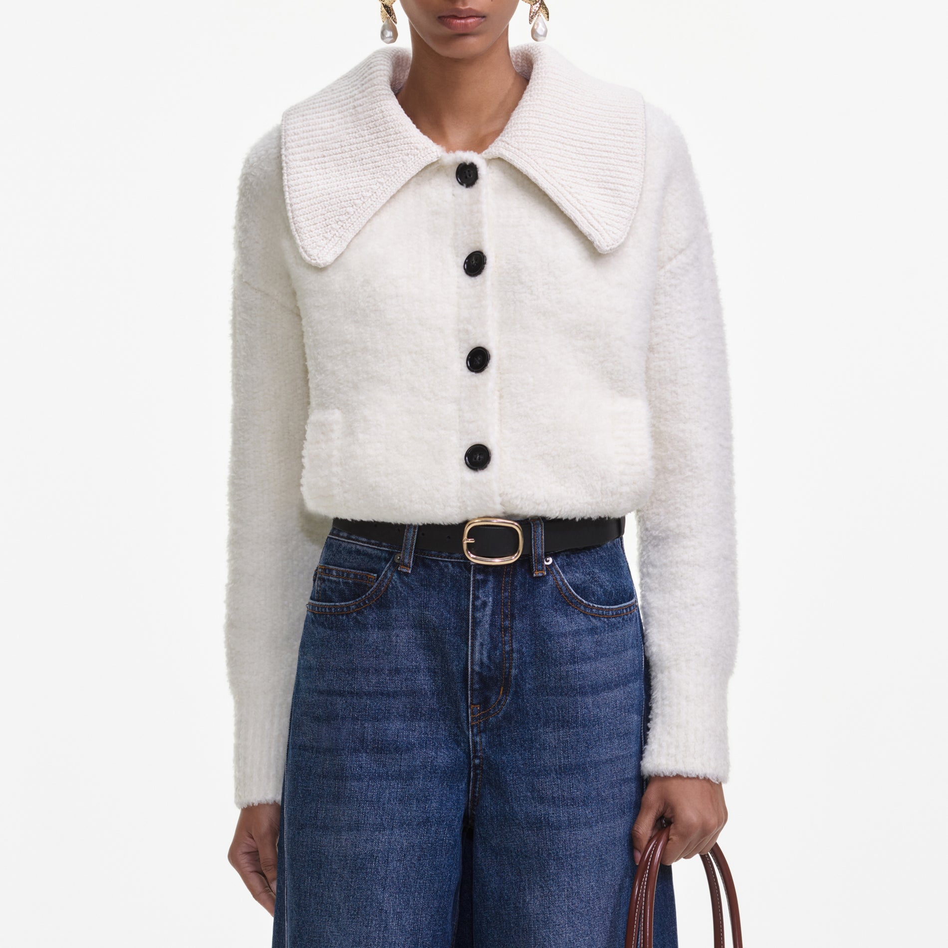 A close up of a woman wearing the Bleached Denim Jeans