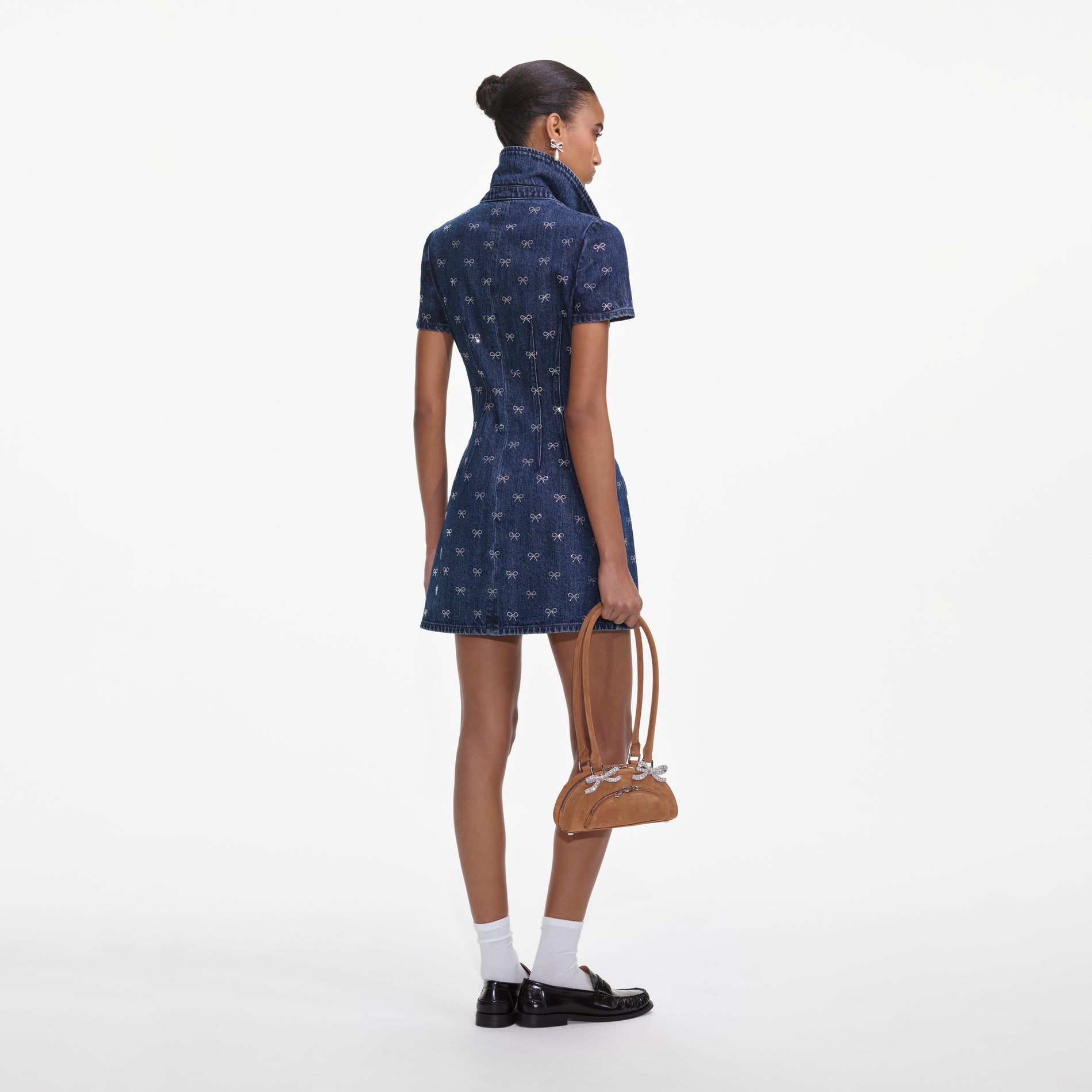 Back view of a woman wearing the Denim Diamante Bow Collared Mini Dress